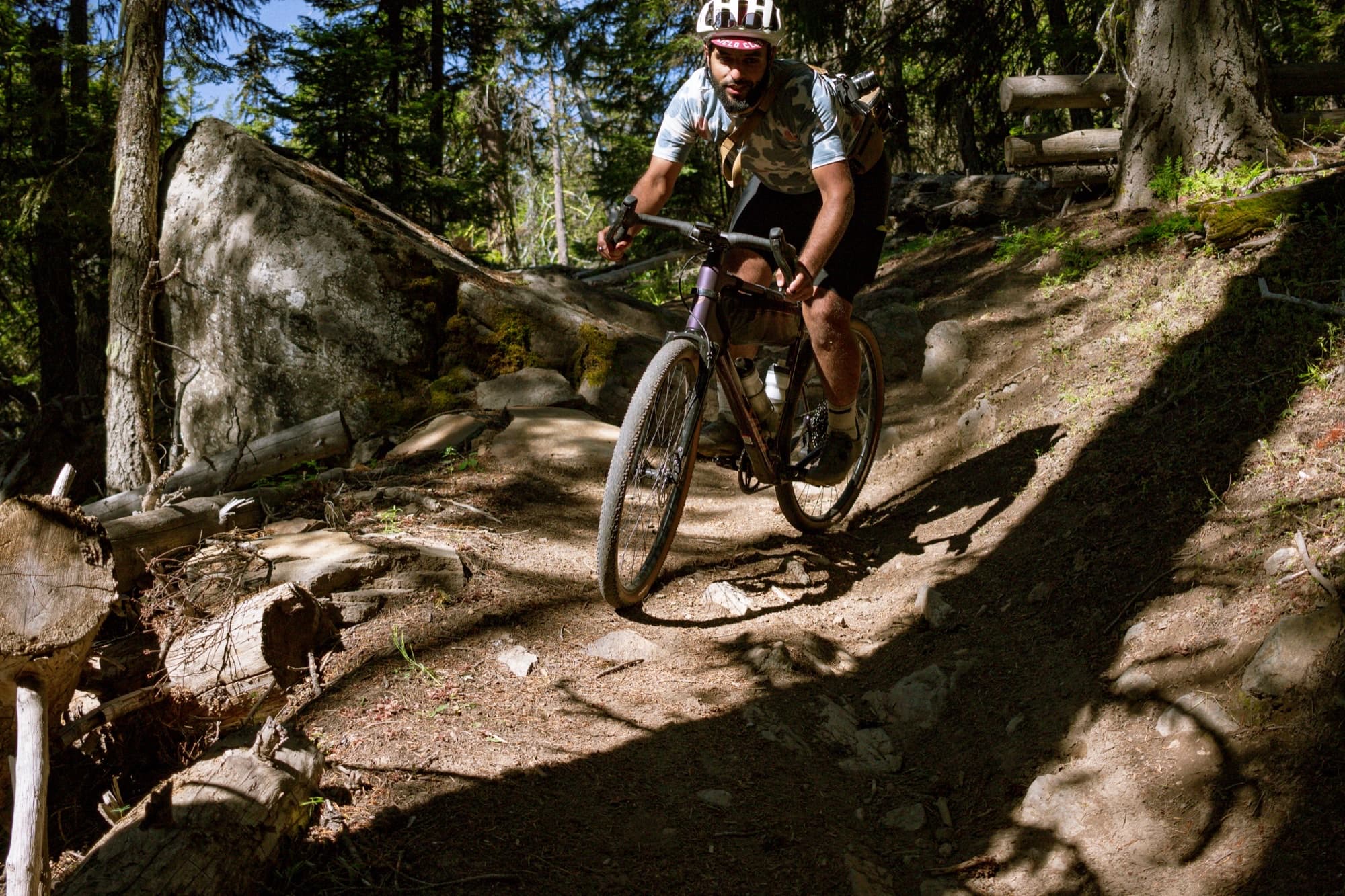Dropping into a root-laced descent under the canopy