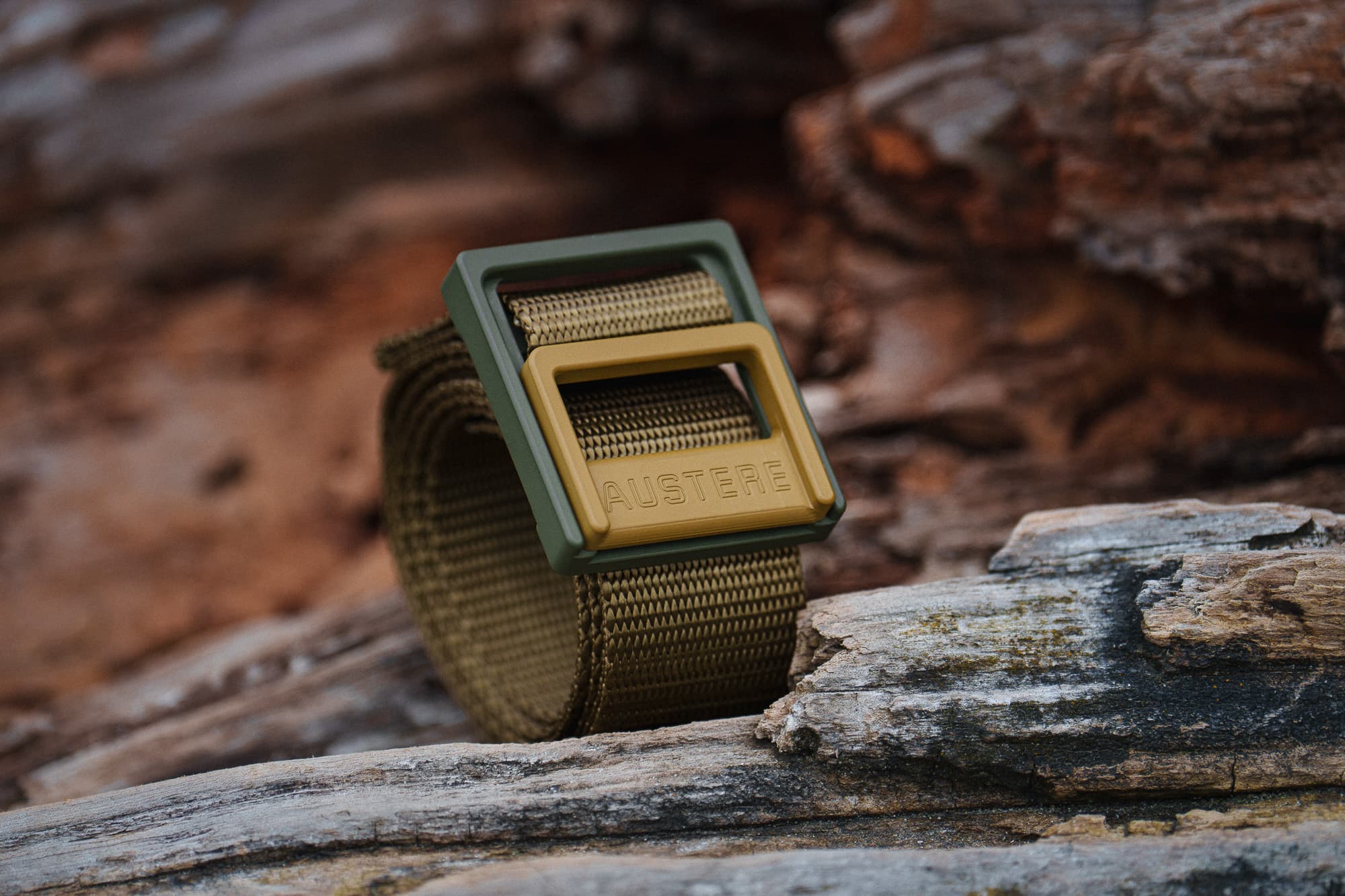 An Austere belt on a log.