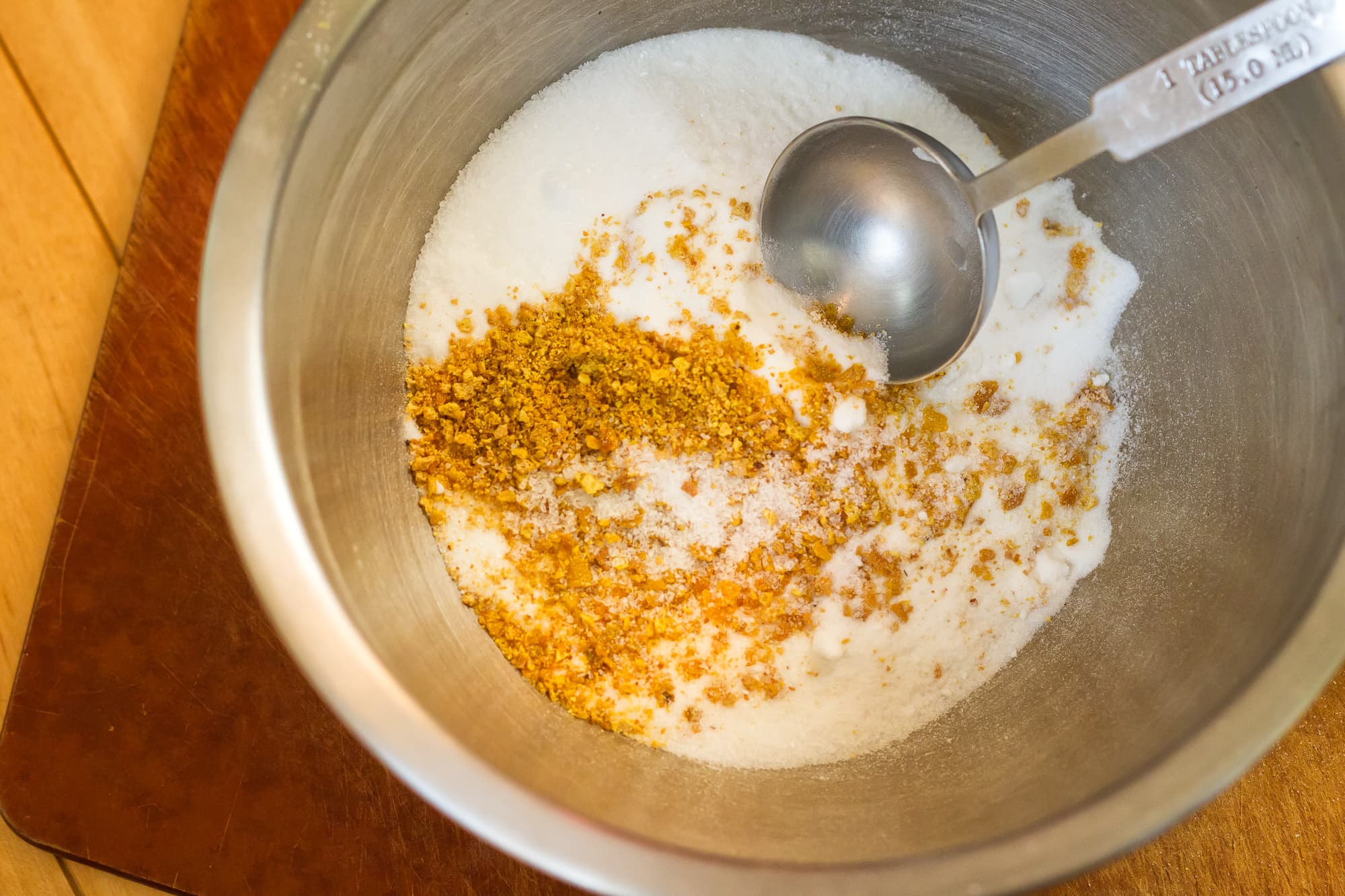 Citrus mix being mixed in a bowl.