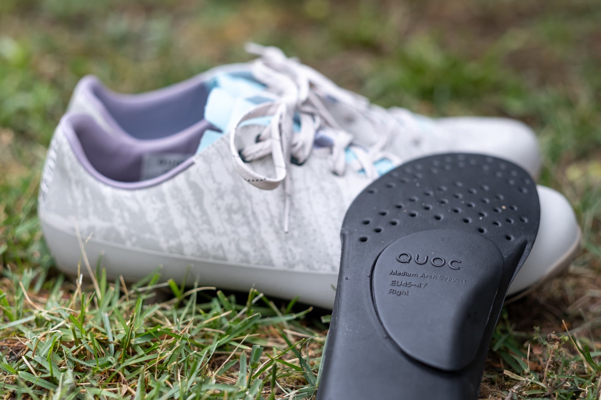 Close-up of a Quoc arch support insert resting against the shoe.