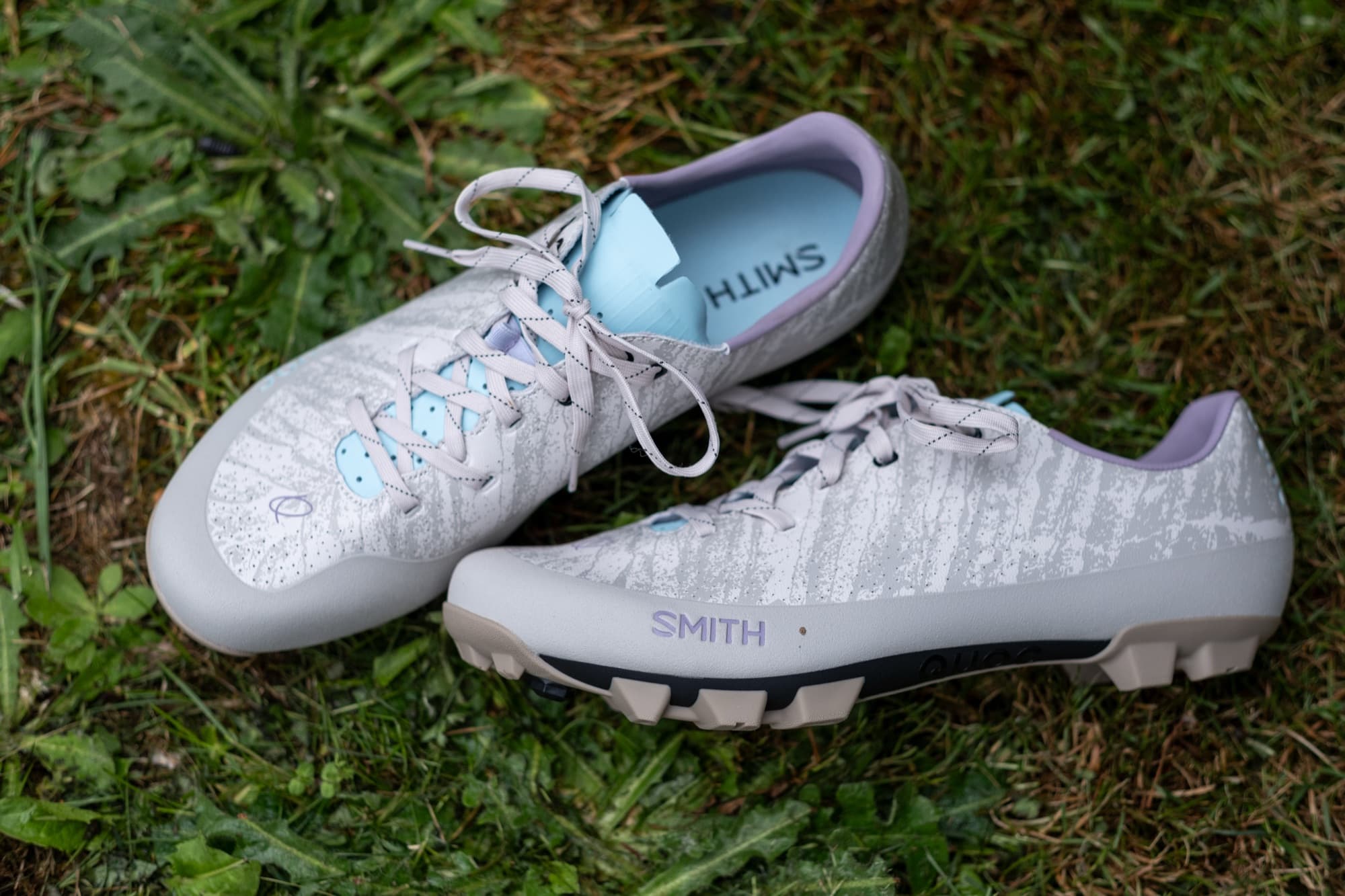 The Smith x Quoc Gran Tourer XC Lace shoes laid out on the grass.