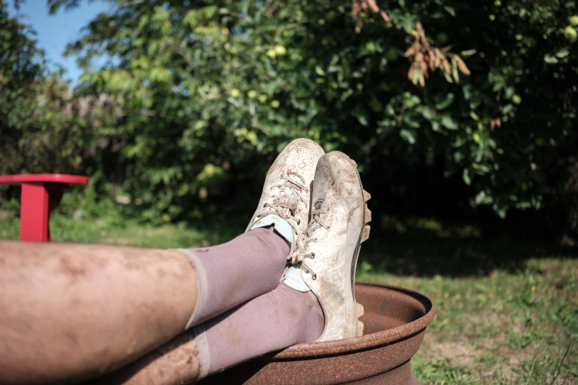 Muddy Gran Tourer XC Lace shoes propped up on the fire pit after a ride.
