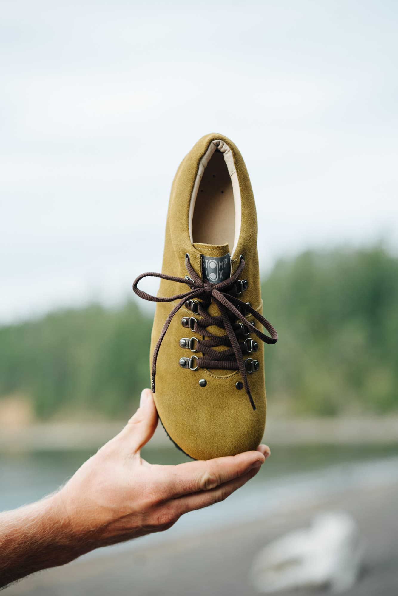 A man holds a cycling shoe.