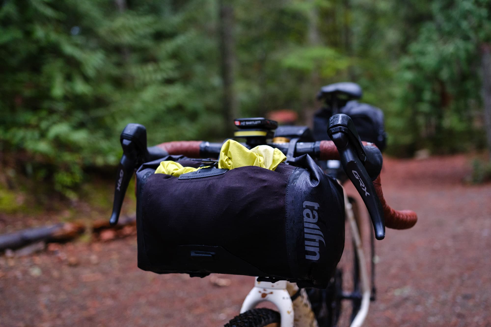 Jeff grabs his jacket out of the4 Tailfin Bar Bag.