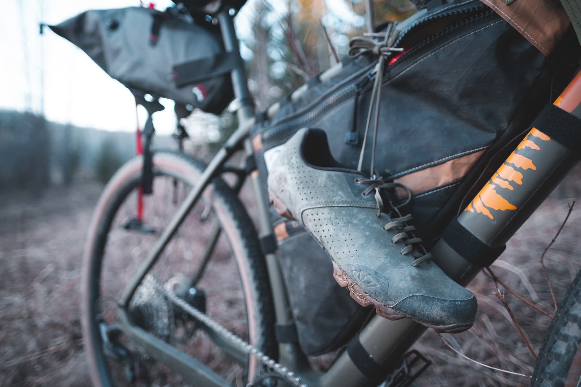 Bike shoes hanging from a bike.
