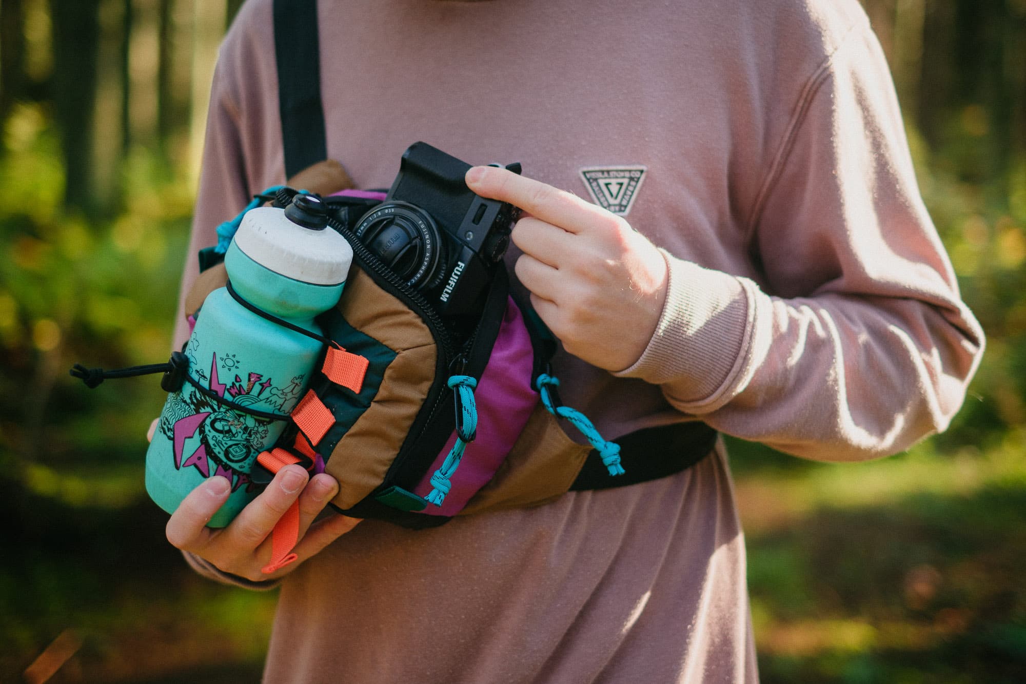 The hip pack loaded with a bottle and camera.