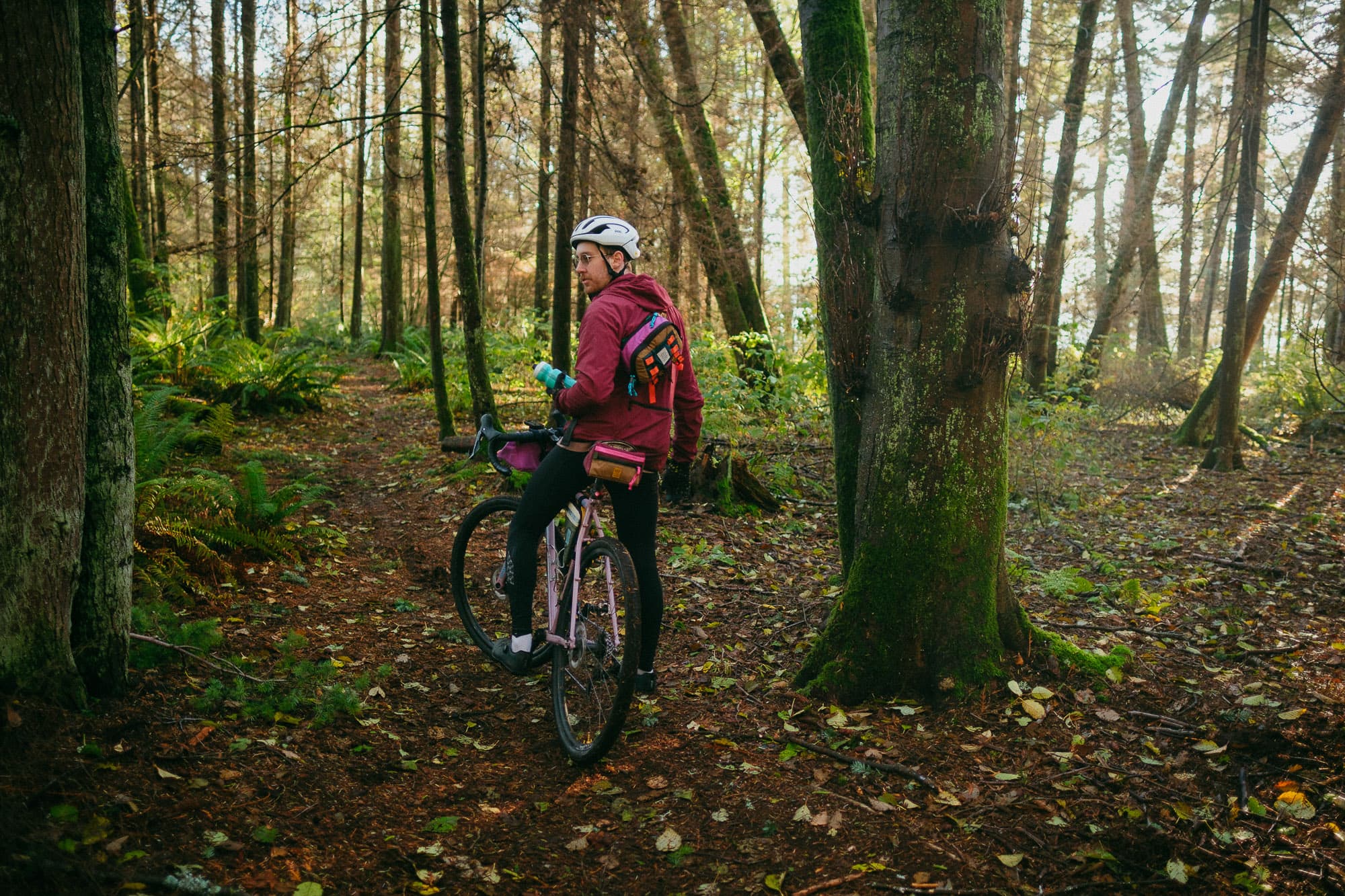 A cyclist in the woods with Topo Bike Bags.