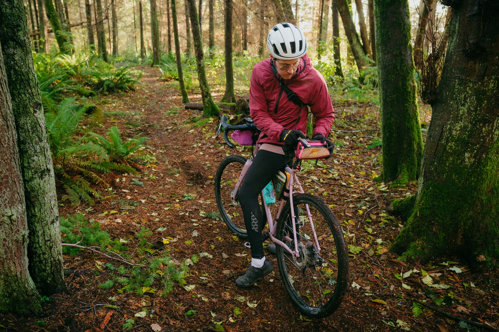 A cyclist accesses a seat bag.