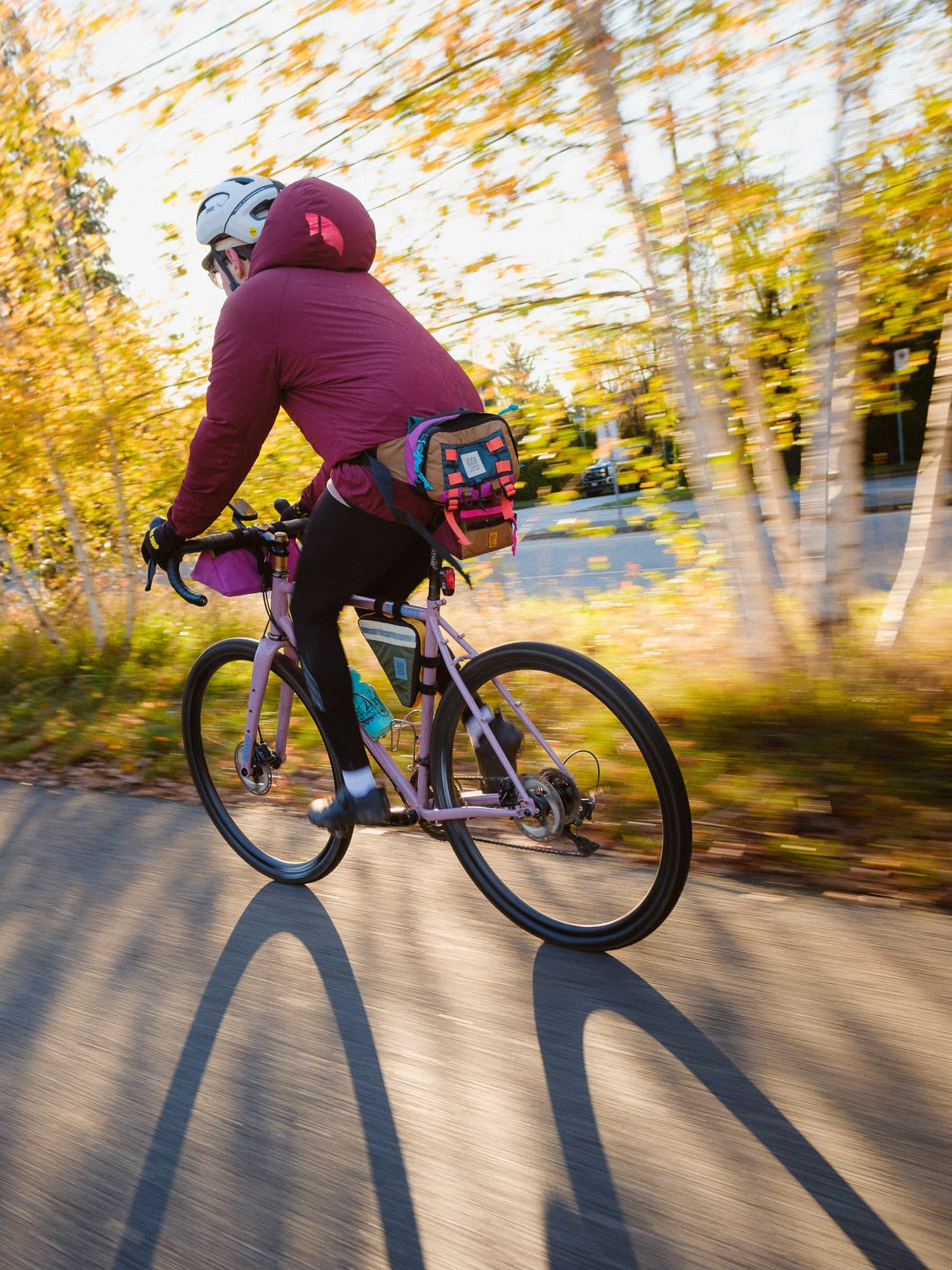 A cyclist with winter sun and moving fast.