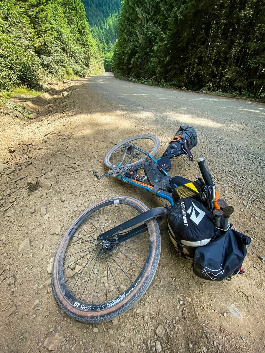 A loaded bikepacking rig on a gravel logging road