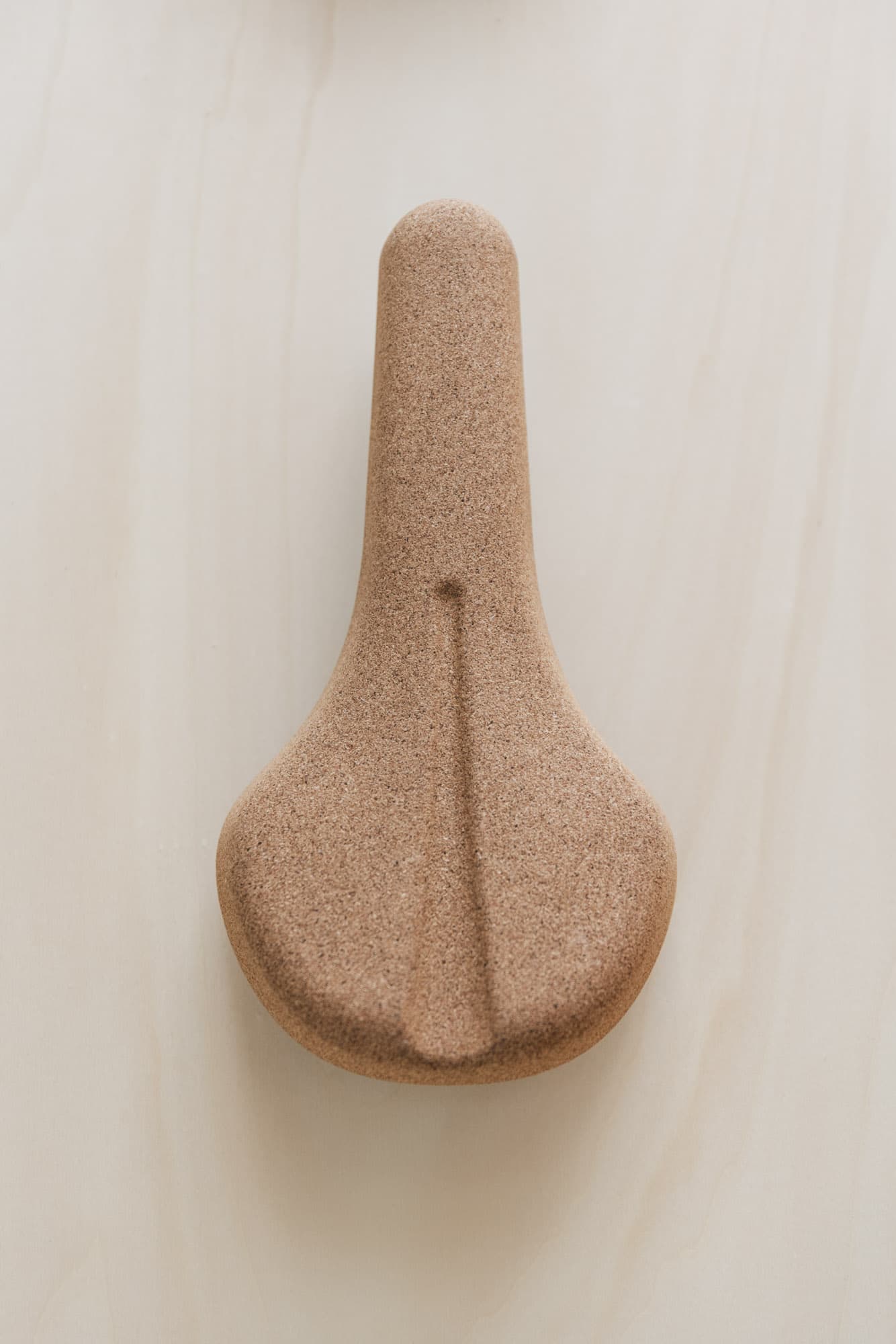 A cork saddle on wood.