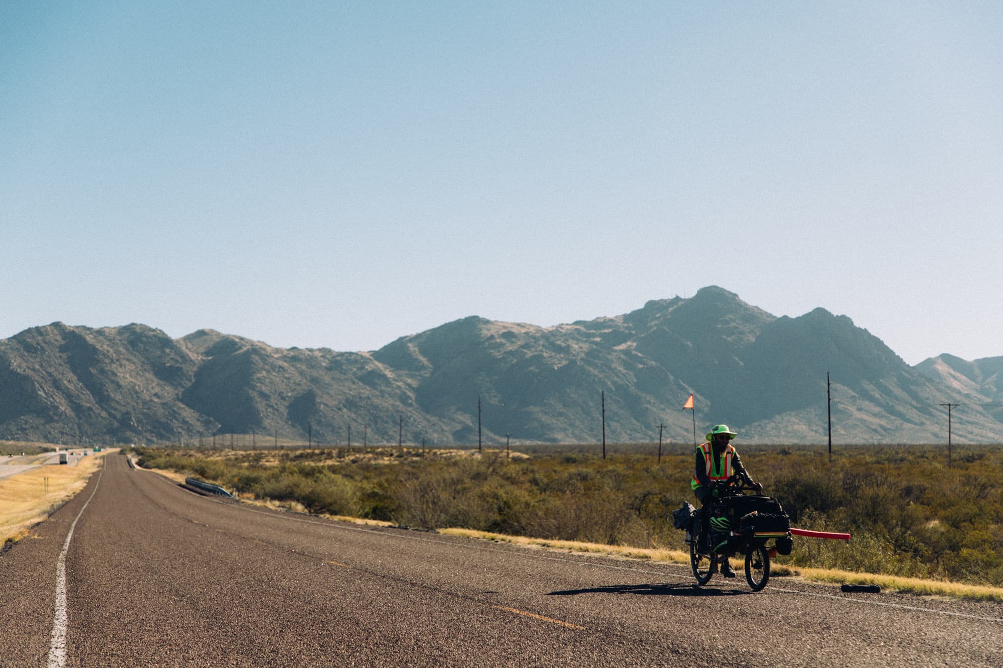 Erik in front of some mountains on his bike.