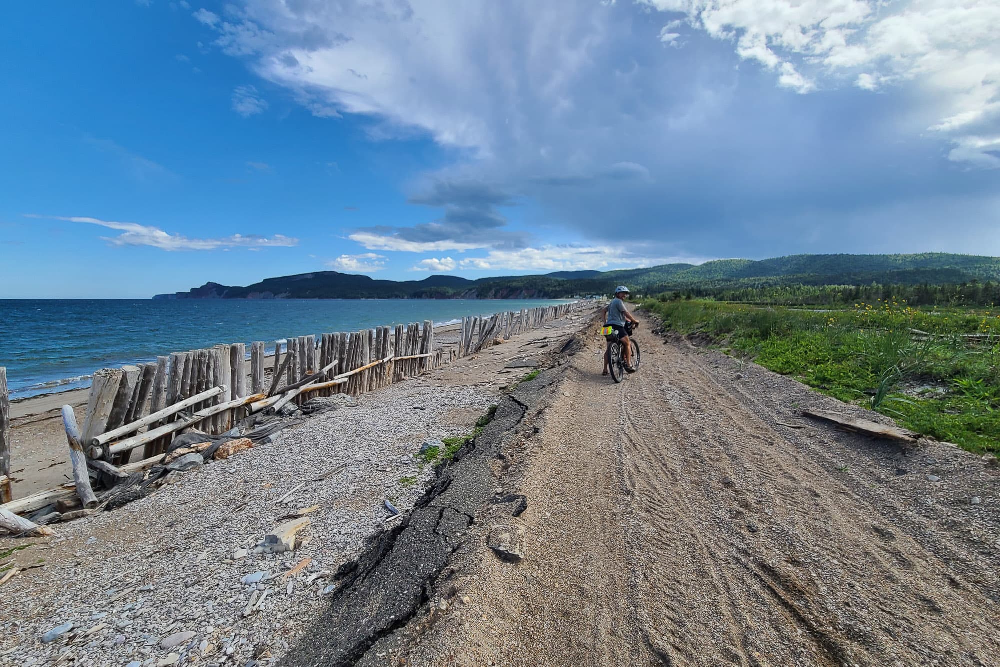 A cyclist on a beach.