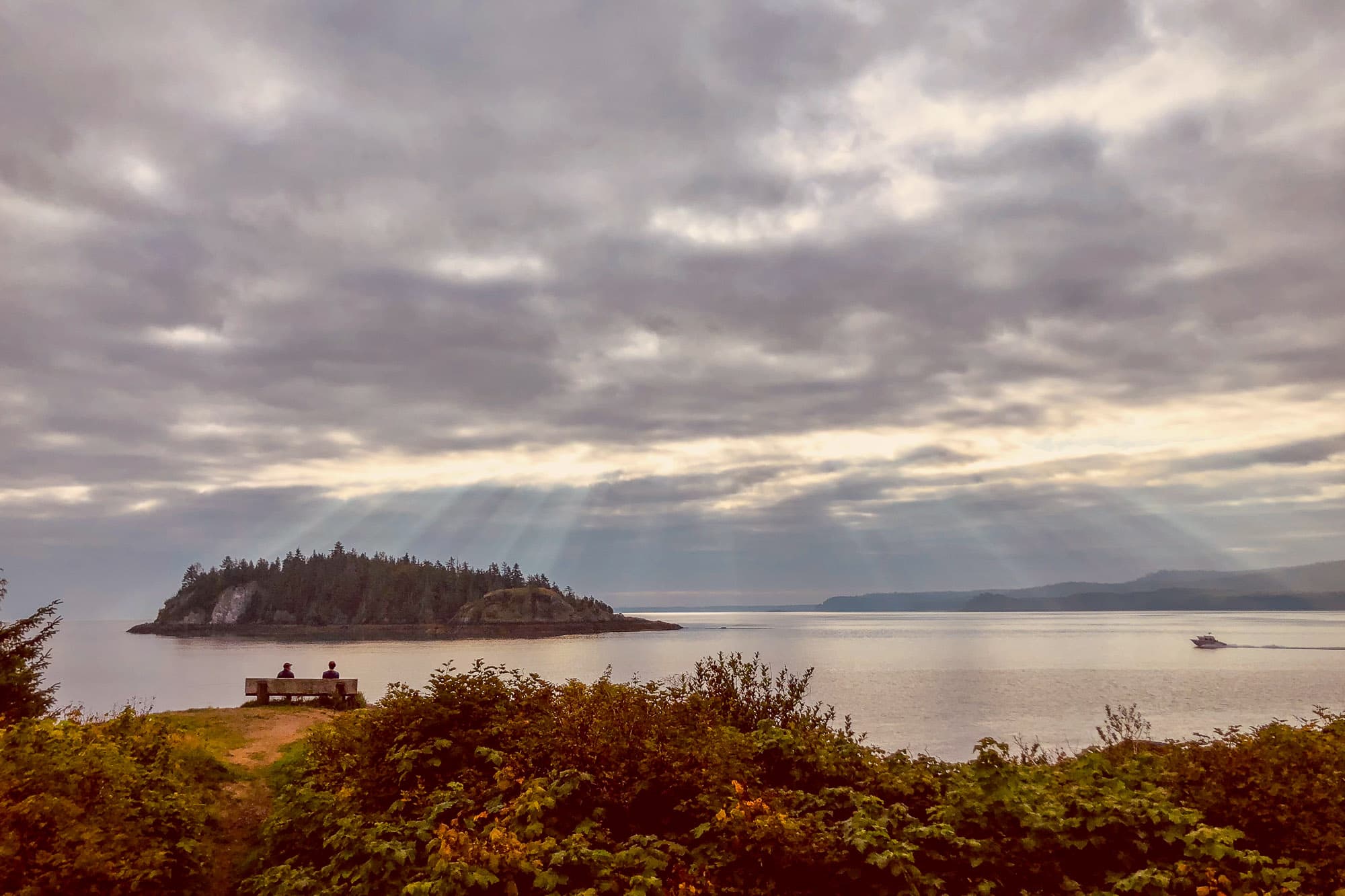 The sun peaks through the clouds on the Haida Gwaii shores.