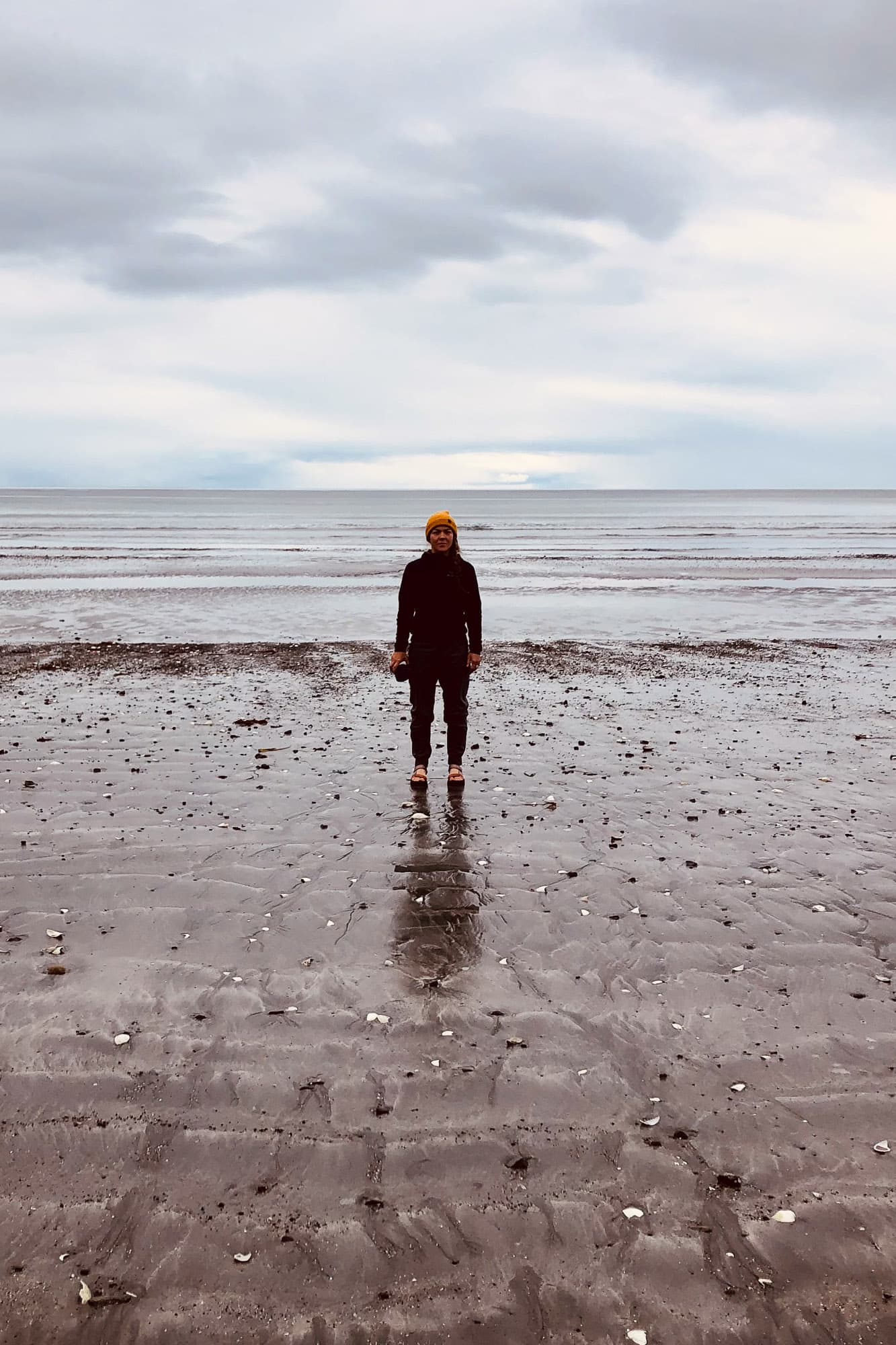 Sarah stands on the beach.