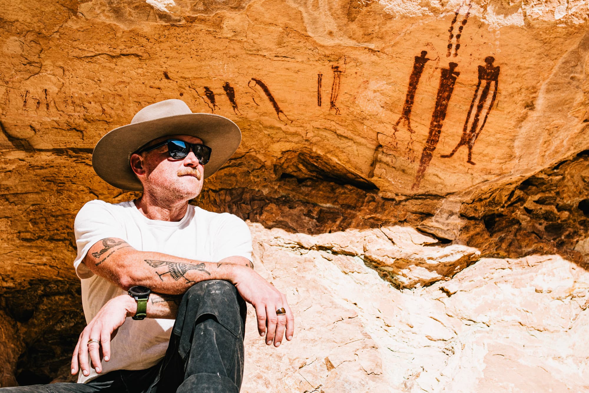 John in front of ancient cave art.