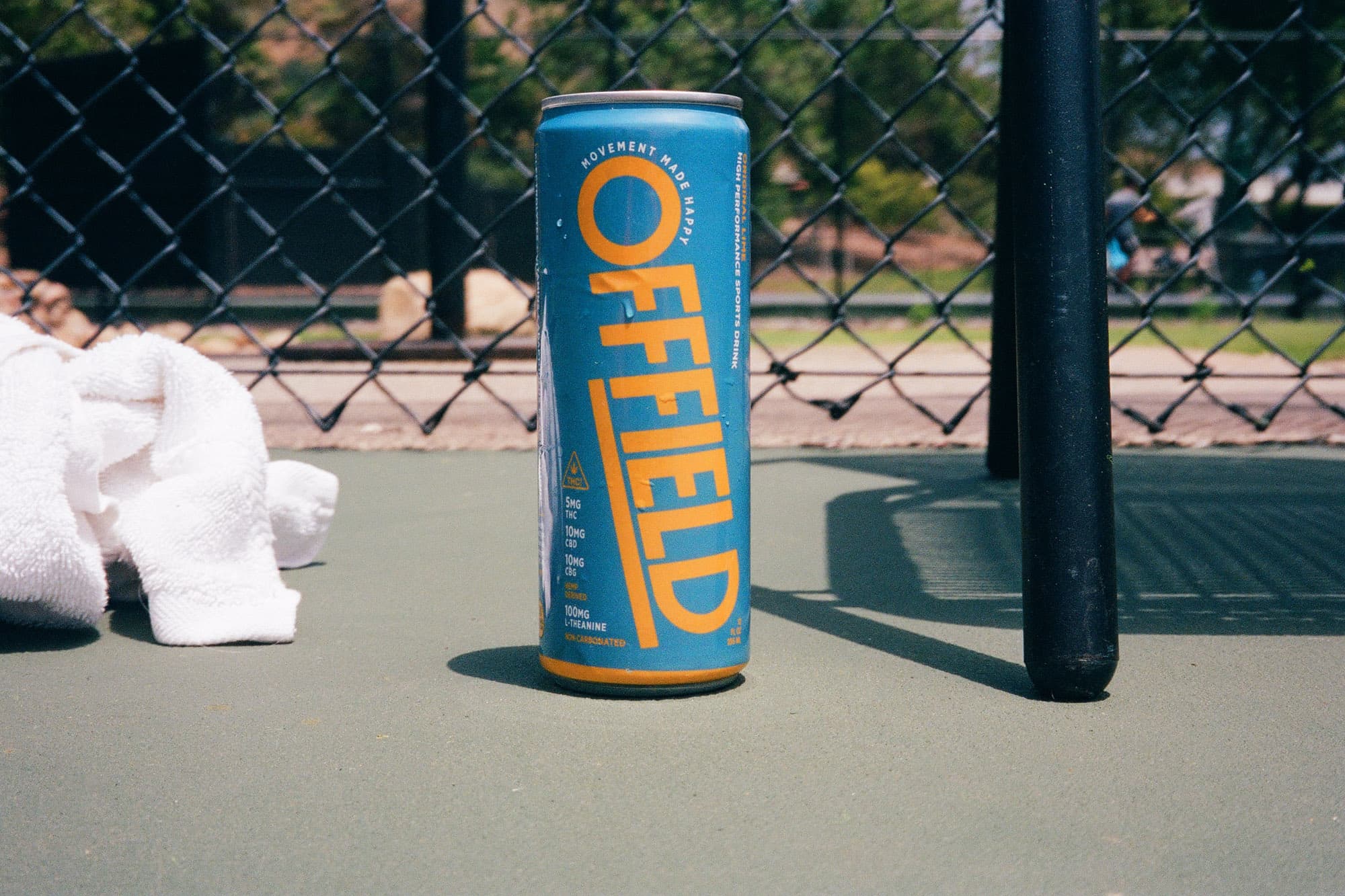 Brand shot can at tennis court.