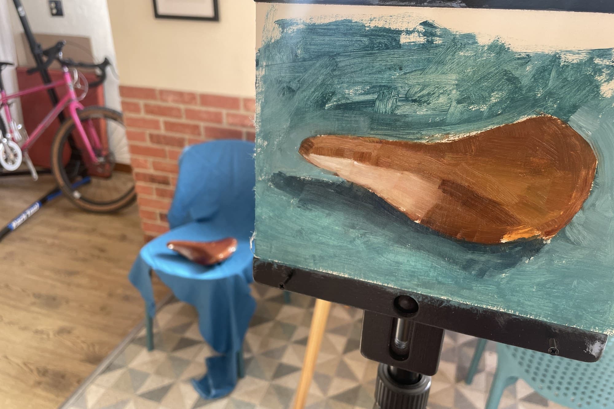 Gouache painting of a leather saddle on the easel