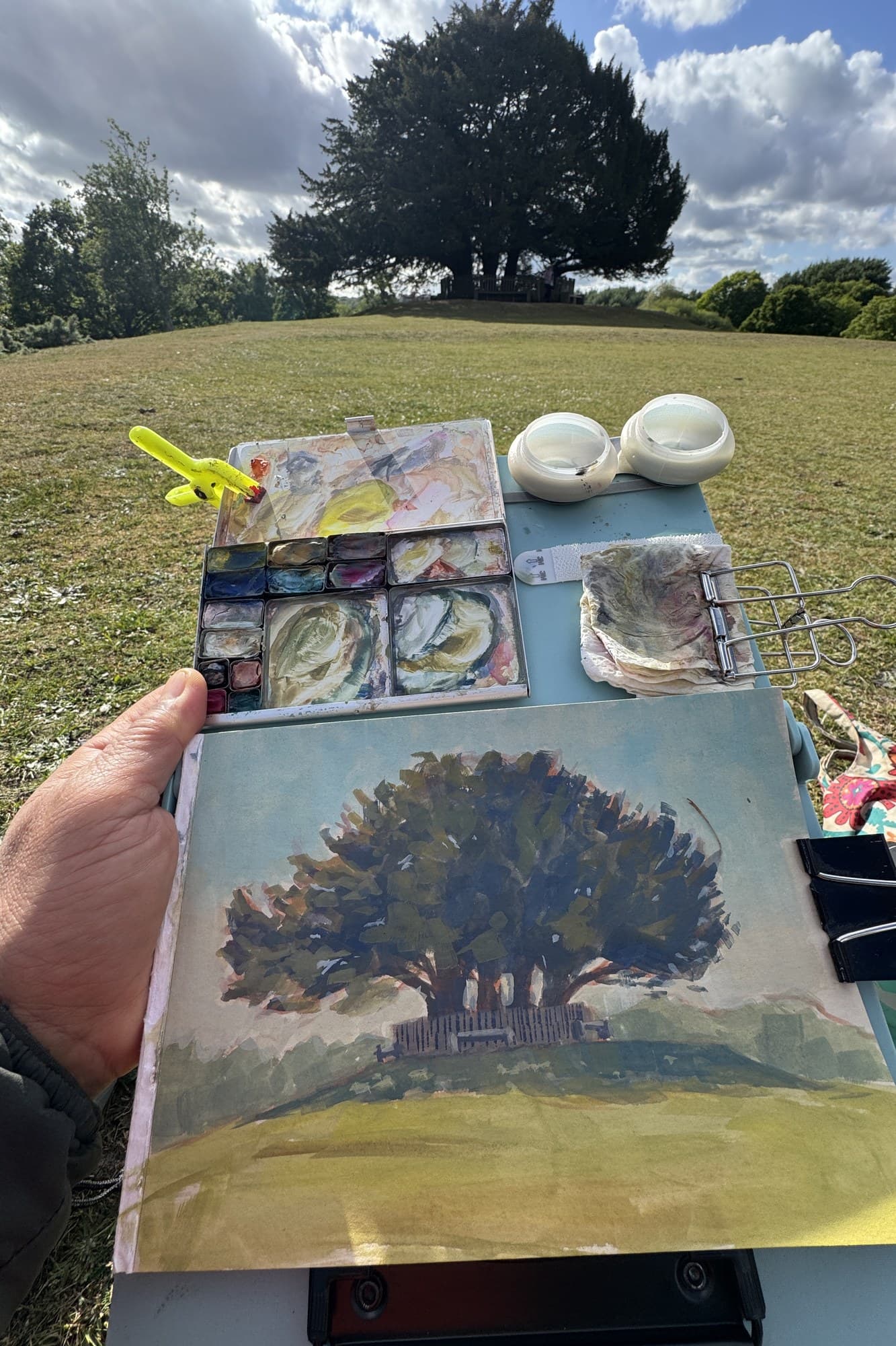 Russ holding a gouache painting of an oak tree
