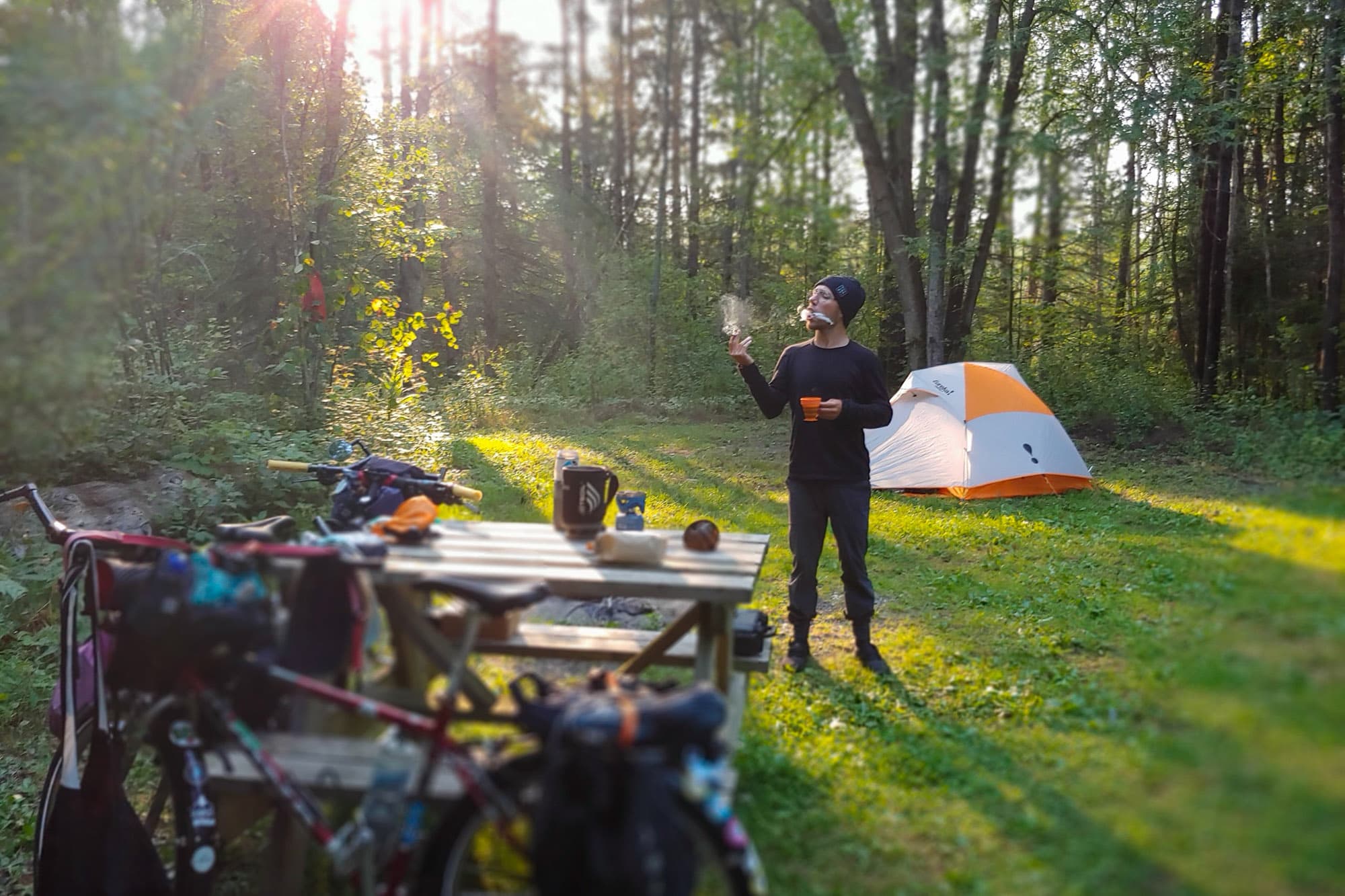 Mat has a puff in camp after a day in the saddle.