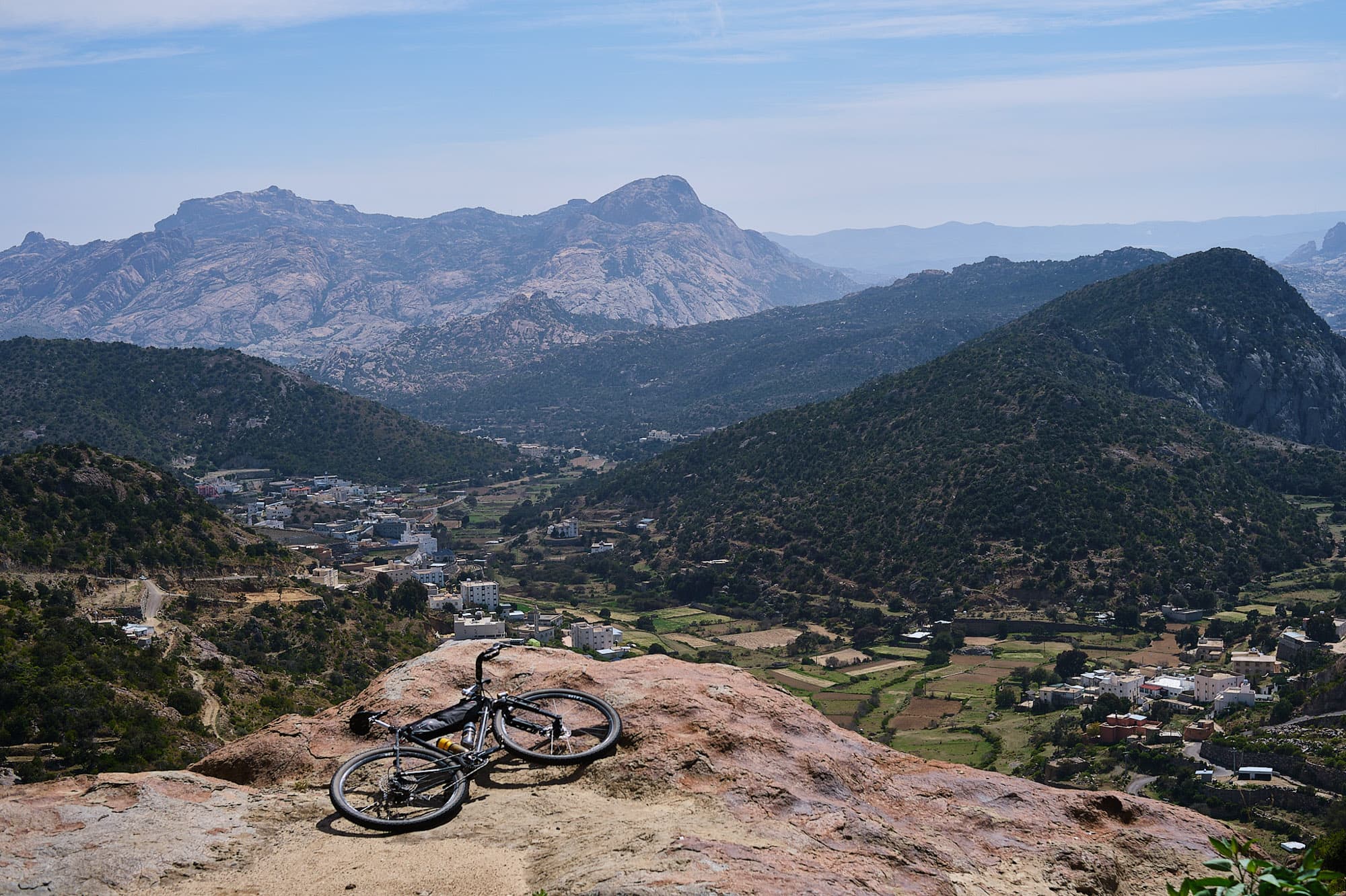 Abes bike overlooking a lush valley.