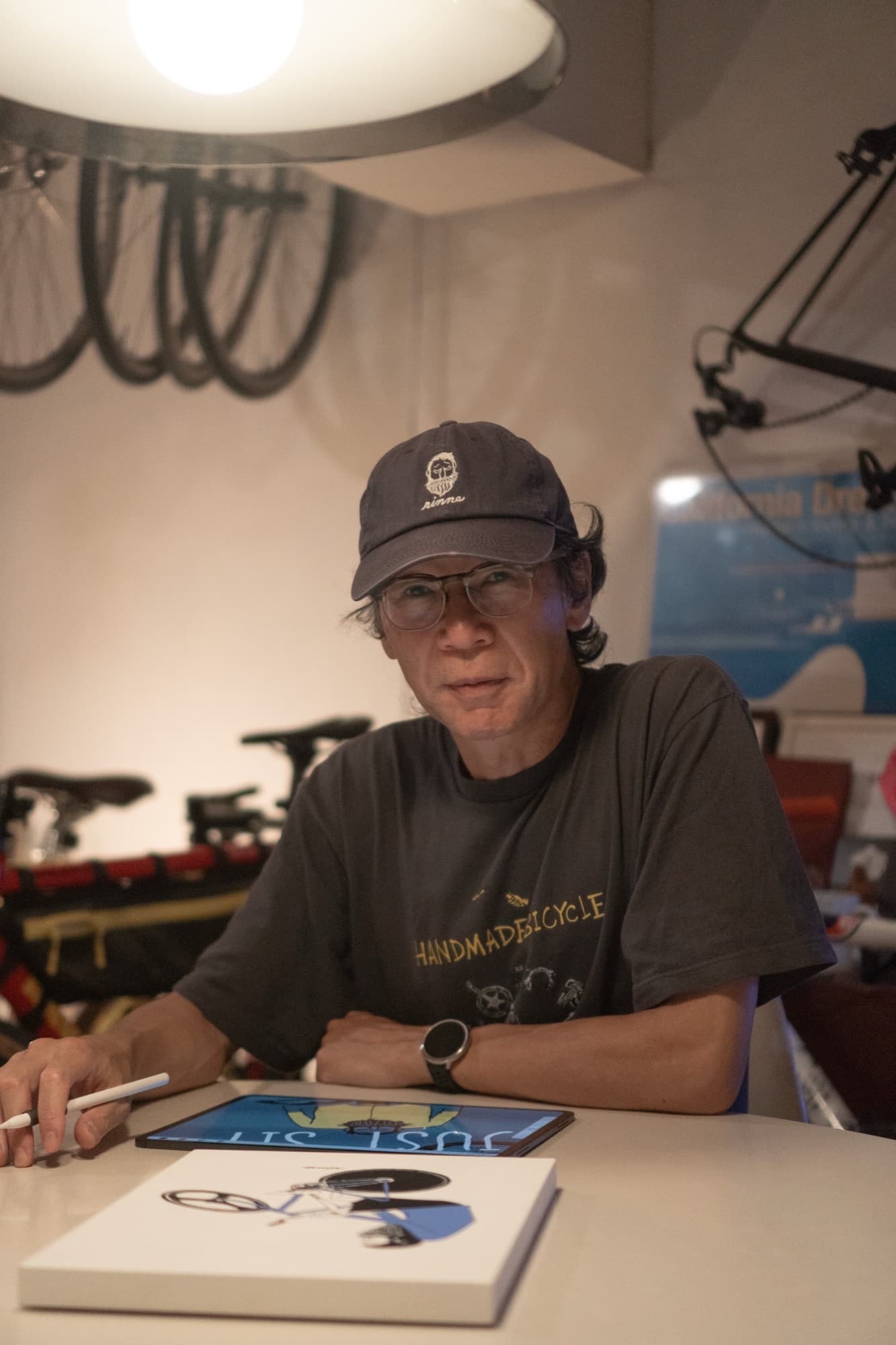 Tetsuro Ohno at his desk sketching Uncle Rinne on a tablet