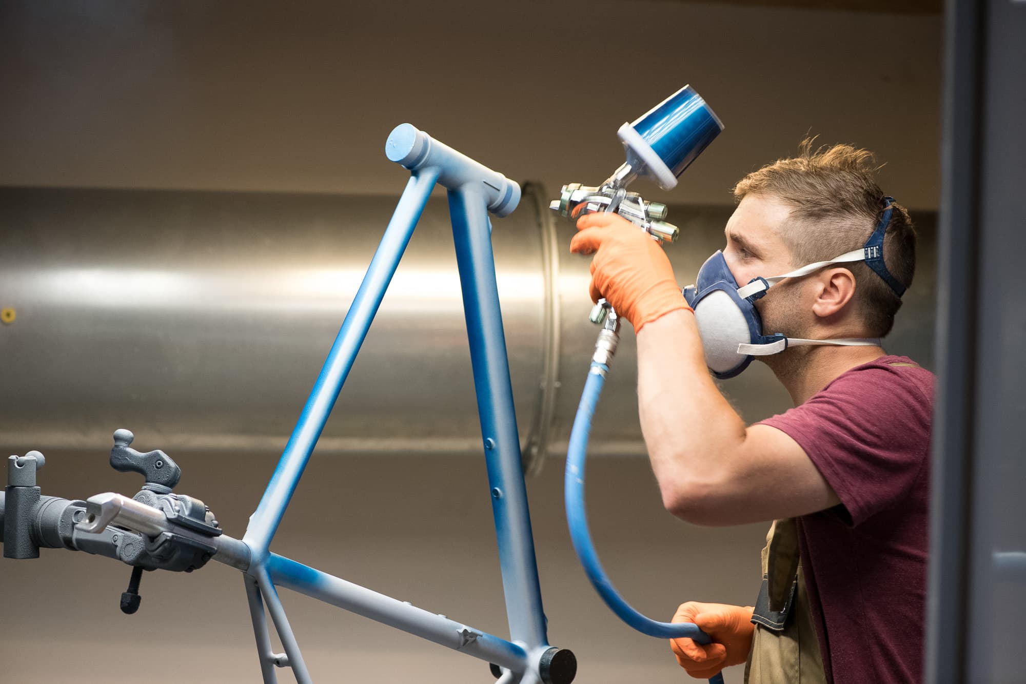 Julien paints a bike.