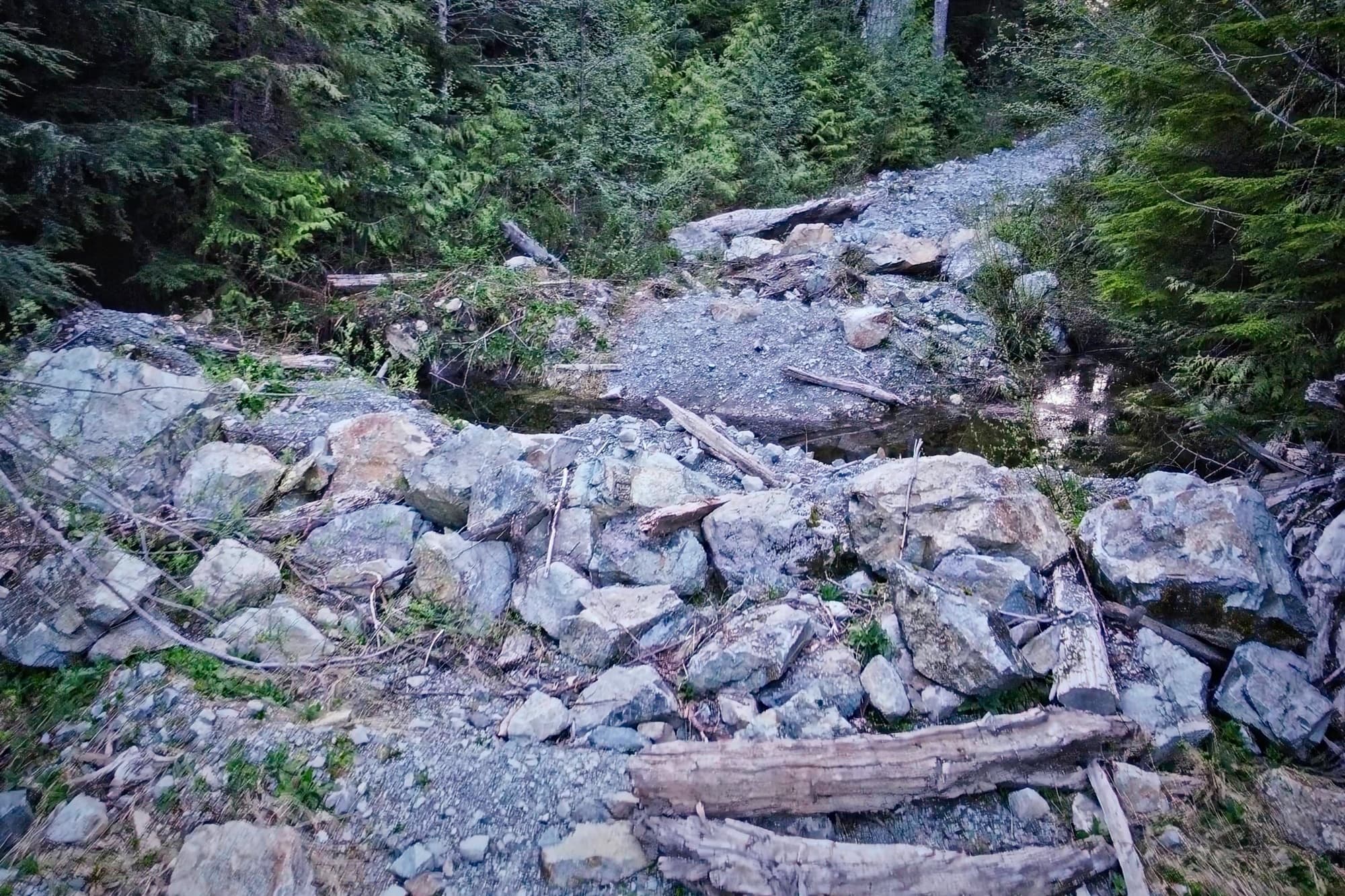 A wall of boulders and debris where the road used to continue