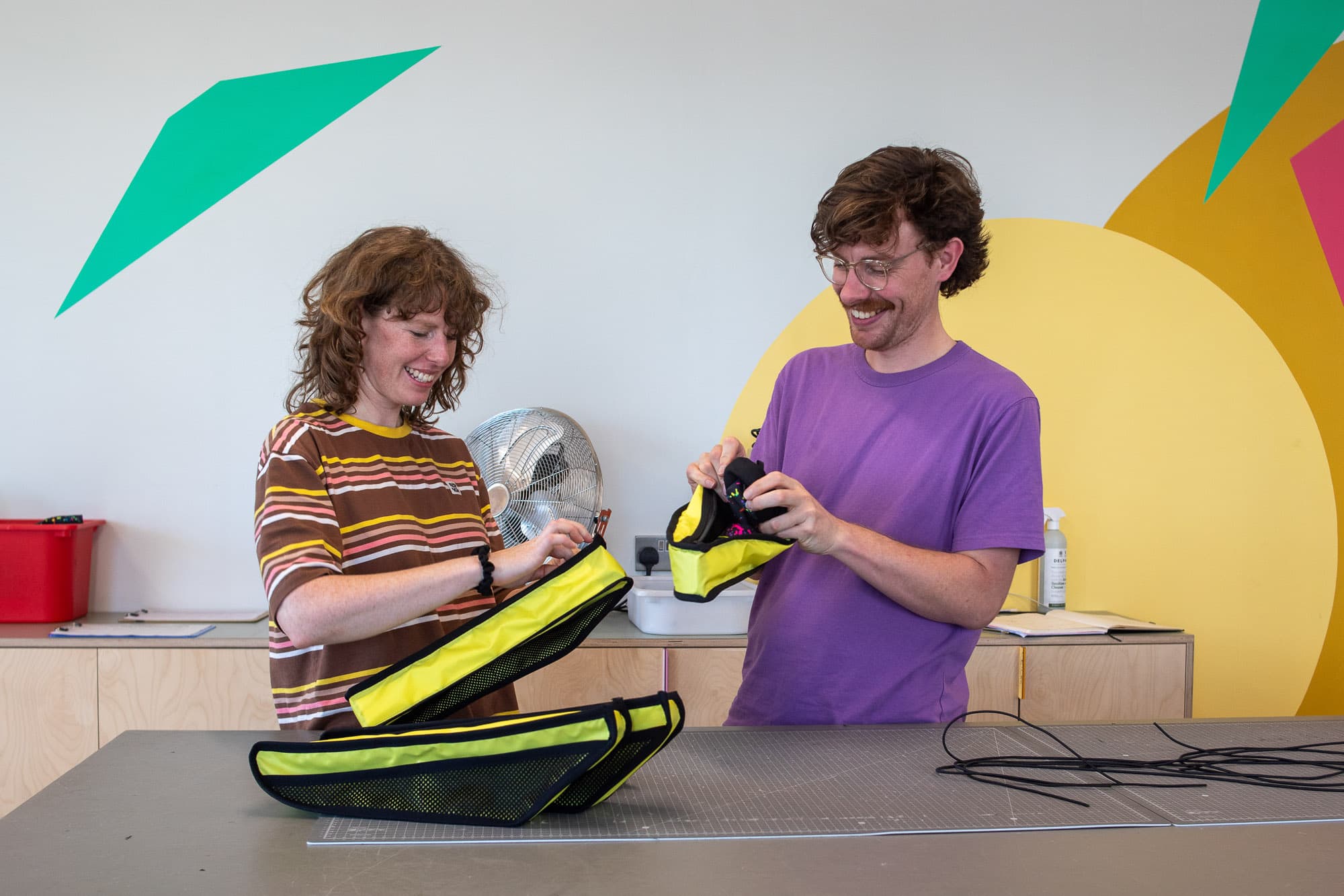 Harry and Vee put the final touches on some bags.
