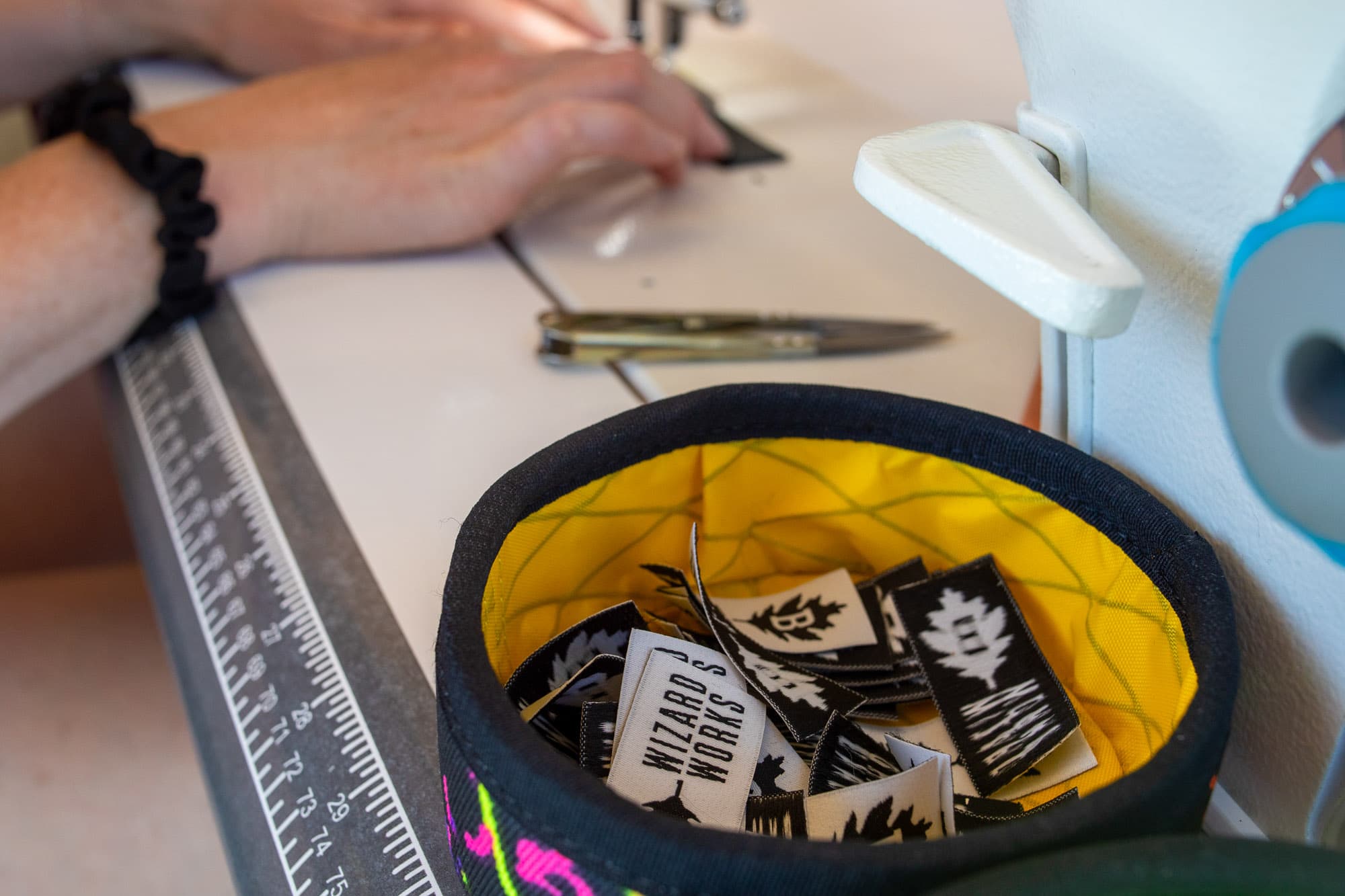 A bag of Wizard Works logos wait to be attached to a bag.