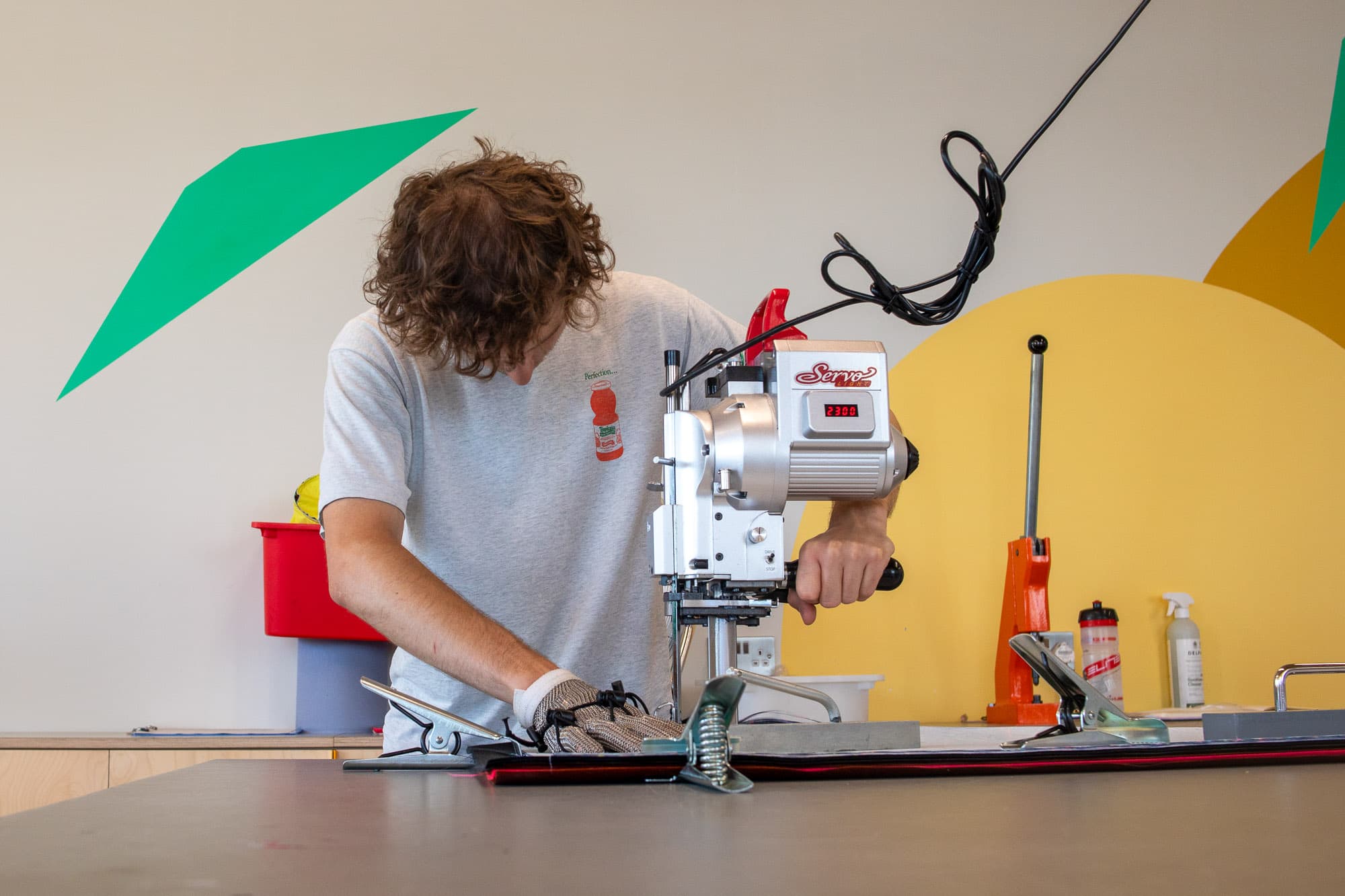 A man cuts a aterial panel.