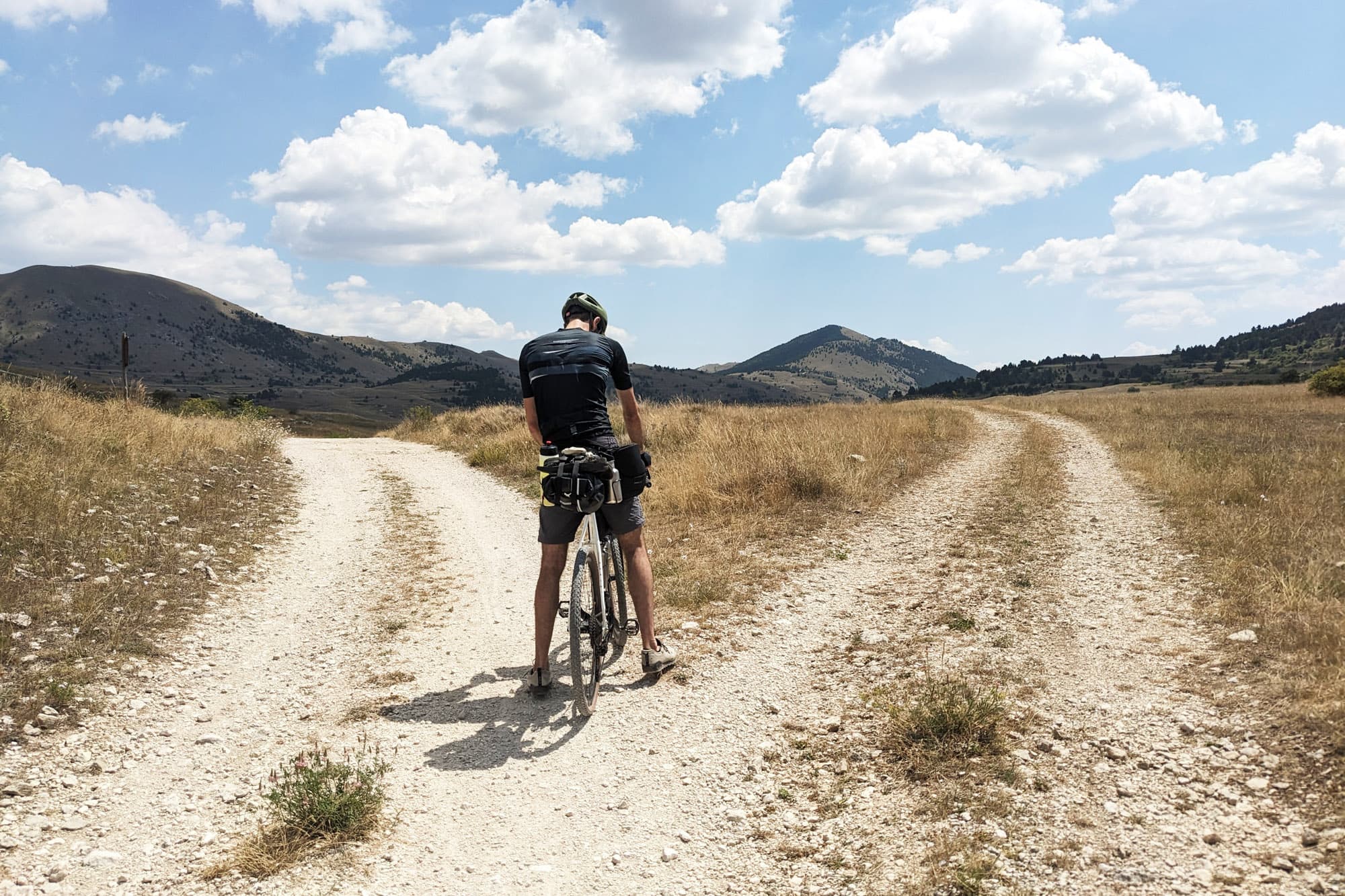 Davide checks the directions at a fork in the road.