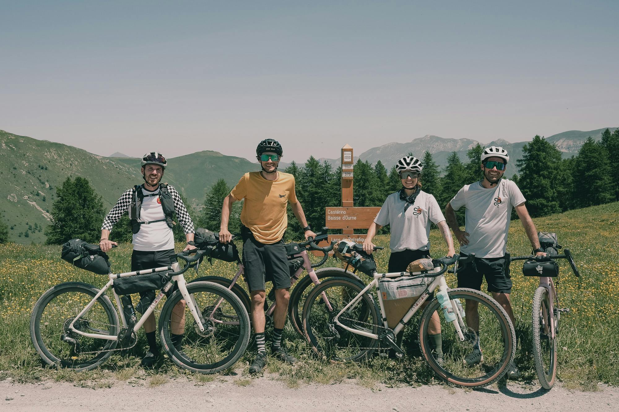 A group of people on a gravel ride pose for a photo.
