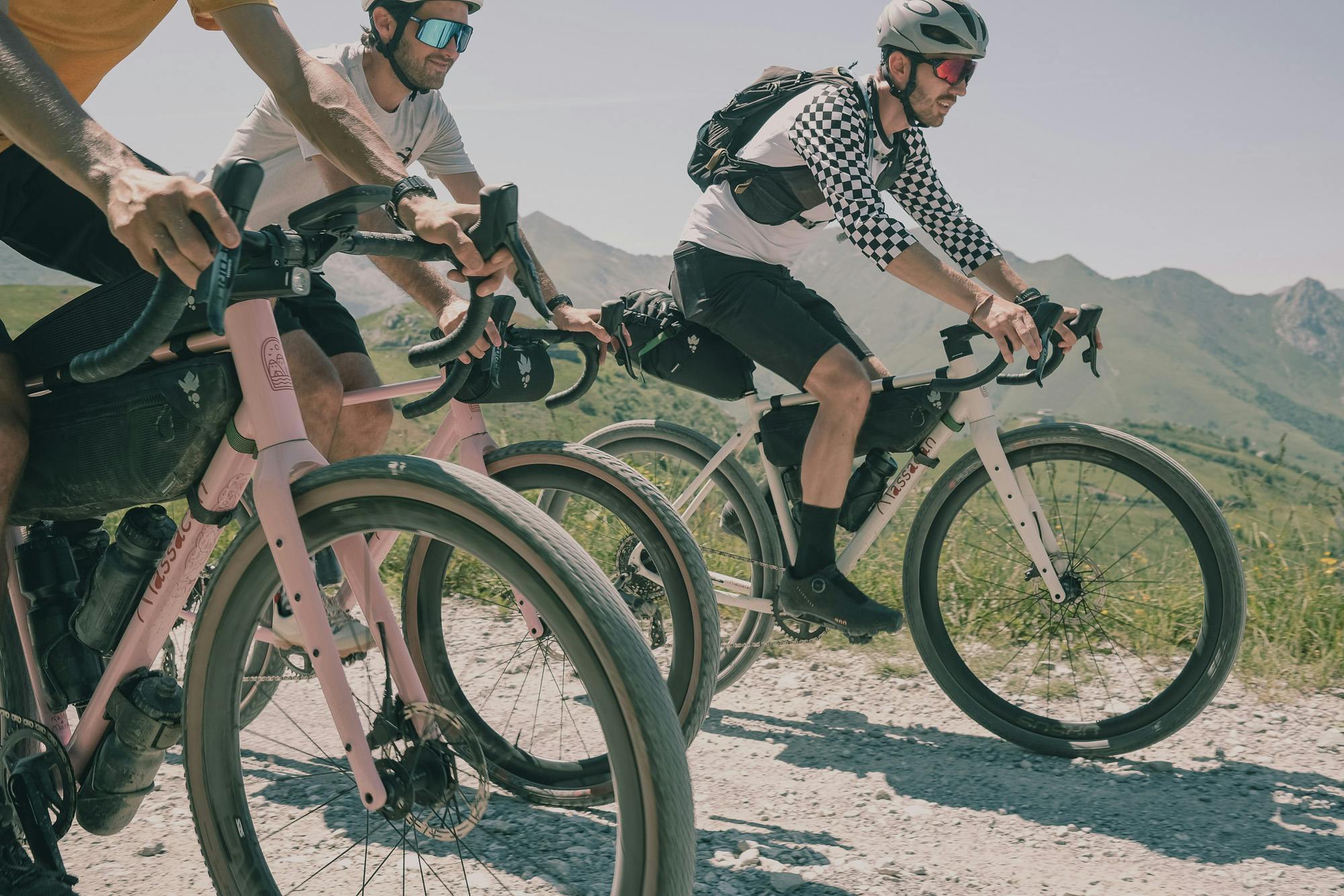 A group of gravel riders head to head on a dirt road.
