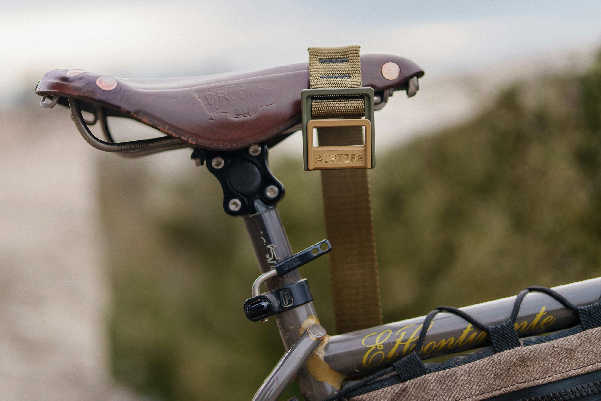 An Austere Lock Belt hangs from a Brooks saddle.