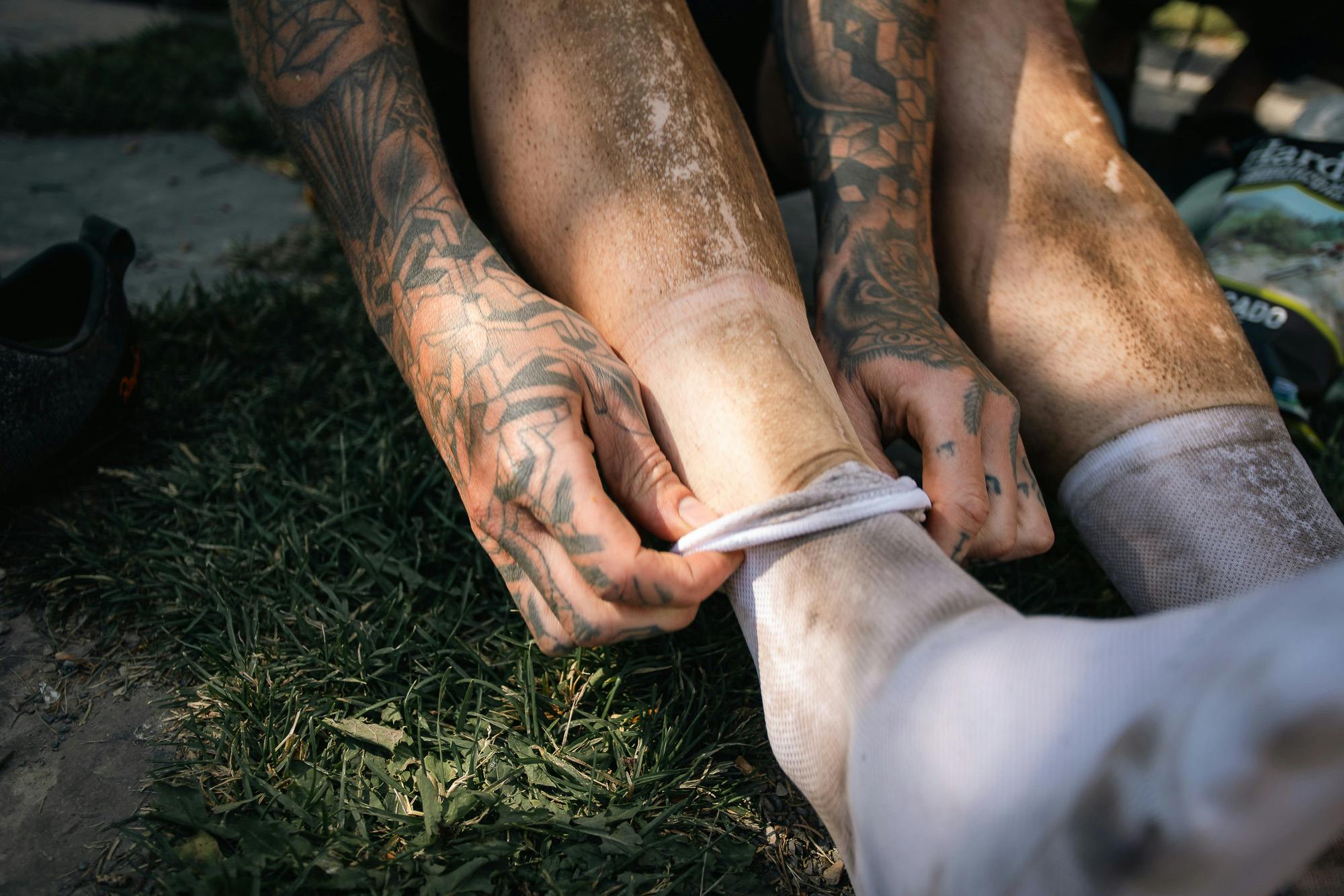 A racer takes his socks off after a hard race.