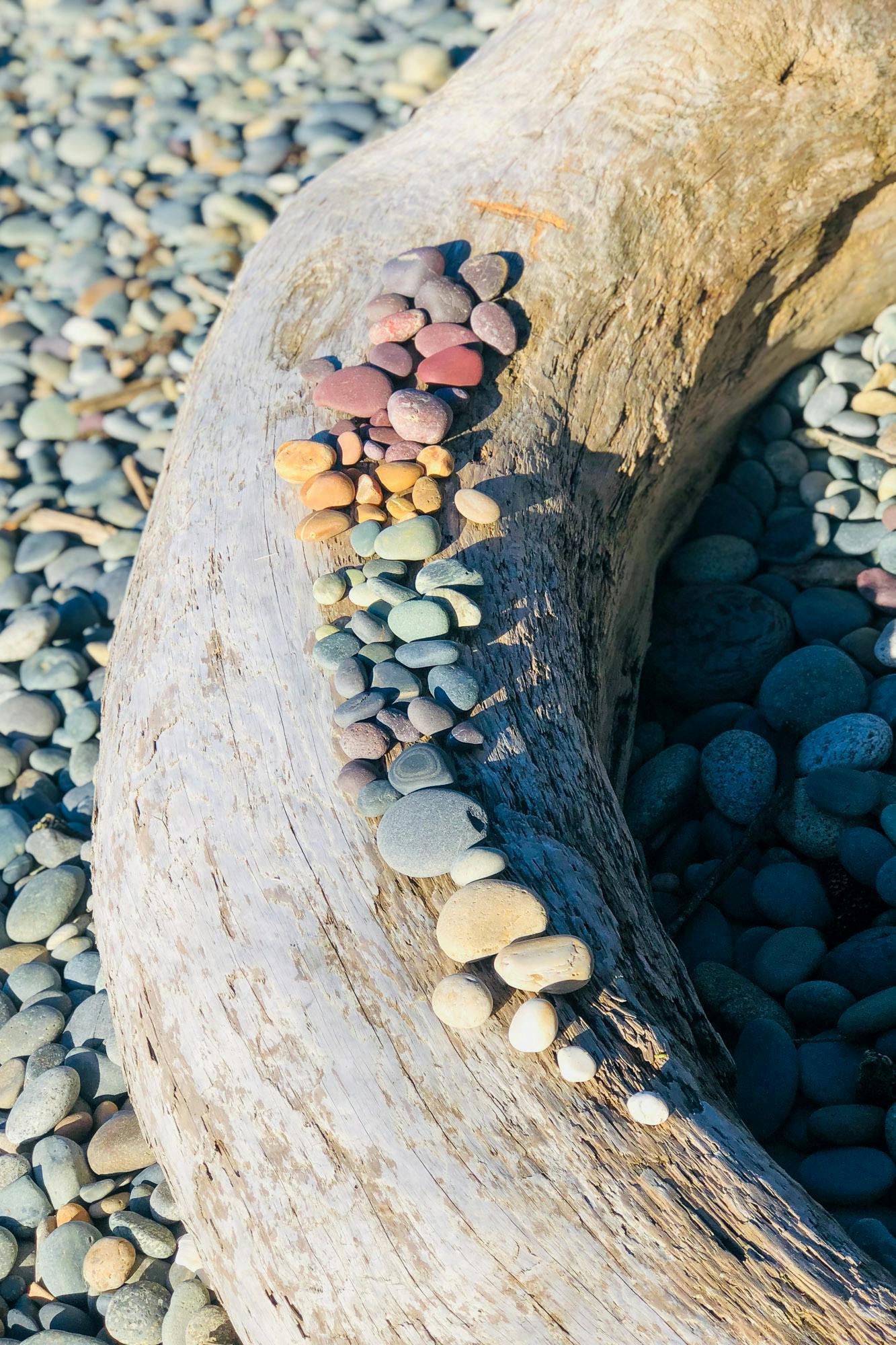 A collection of rocks organized in a rainbow.