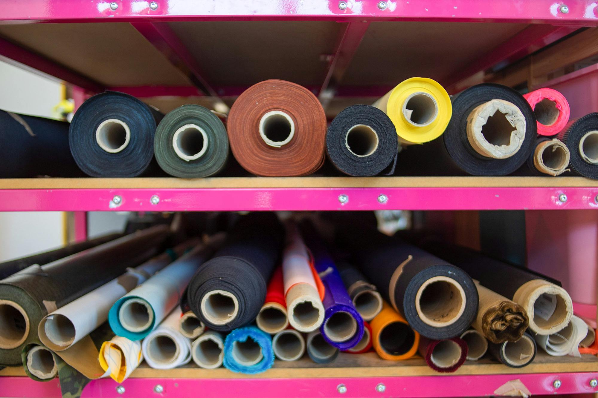 Rolls of material on a shelf.