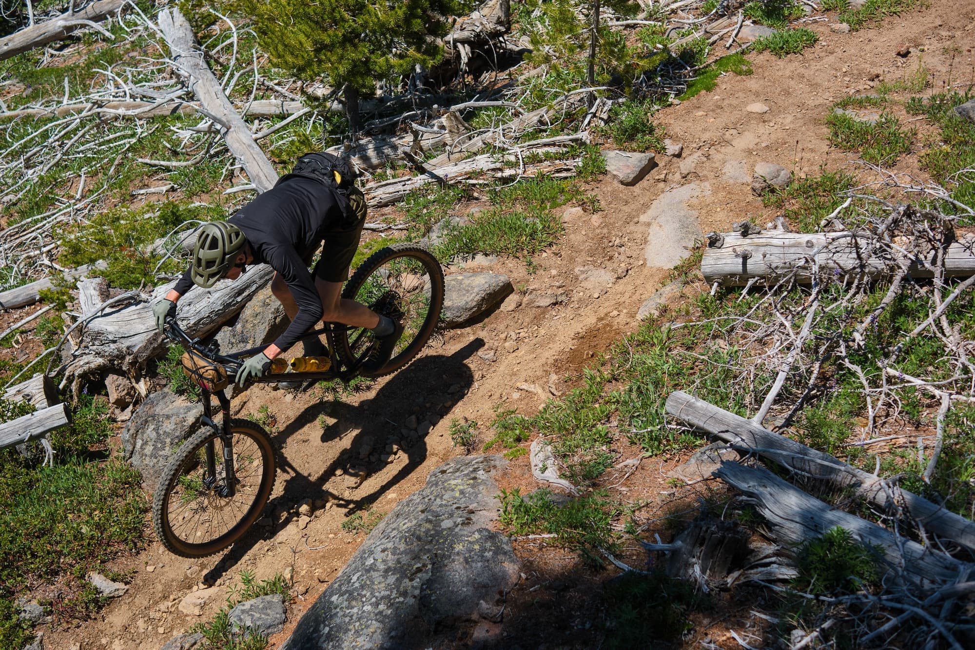 Shadow riding down the loose ridgeline