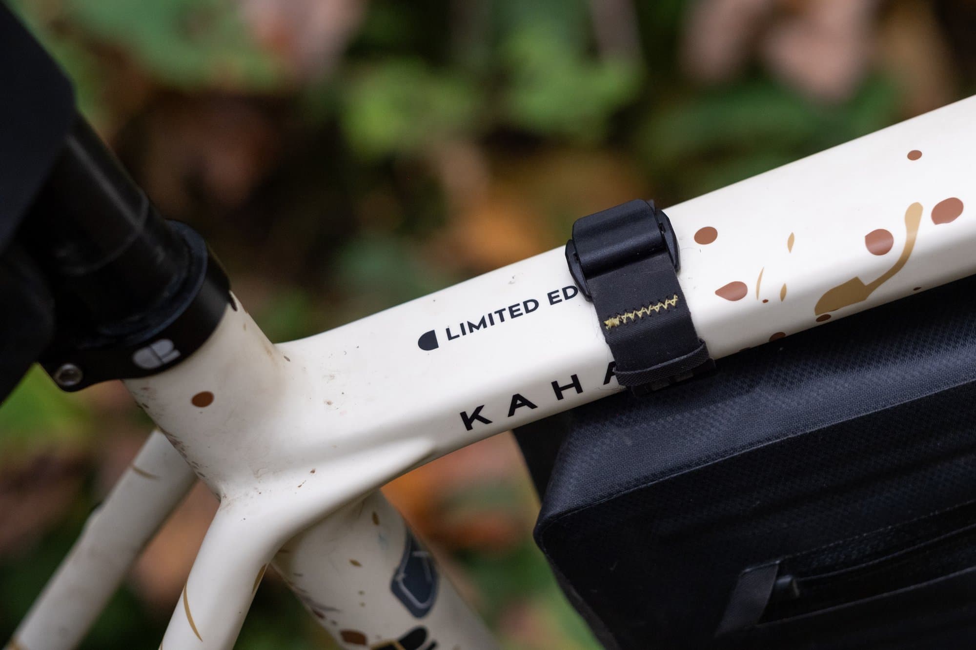 A shared strap holding the Top Tube Pack and the front of the Frame Pack.