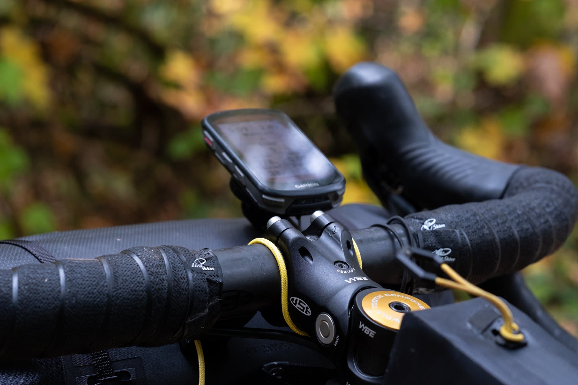 The BarSpace mount and its yellow Stability Cord around the stem, with a Garmin on top.