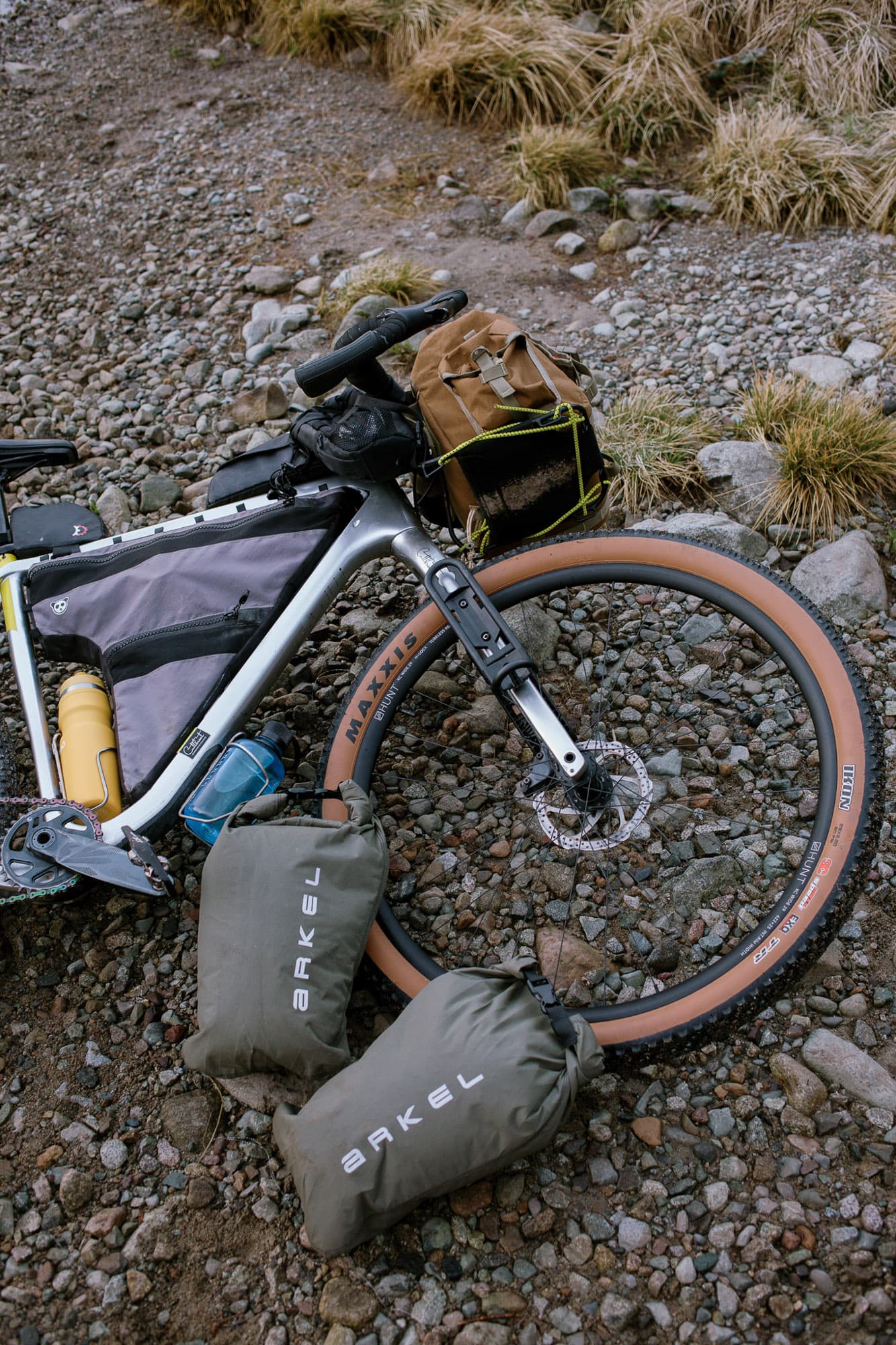 Loaded bike laid on the ground with gear.