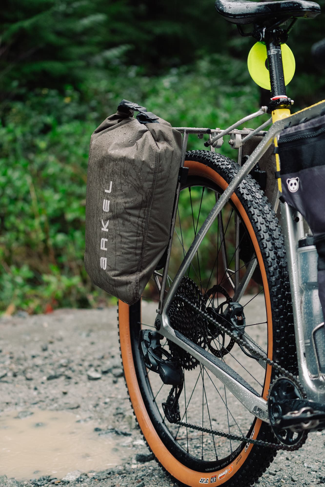 Three-quarter view of the bike rigged with fork bags.