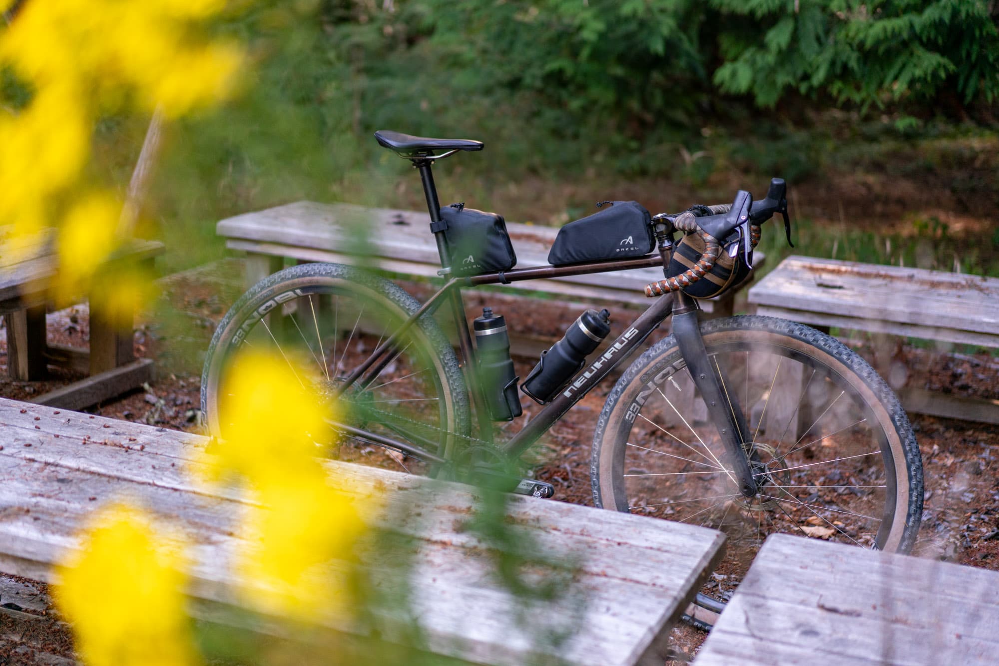 The BigLeaf parked at a picnic table, yellow flowers in the foreground.