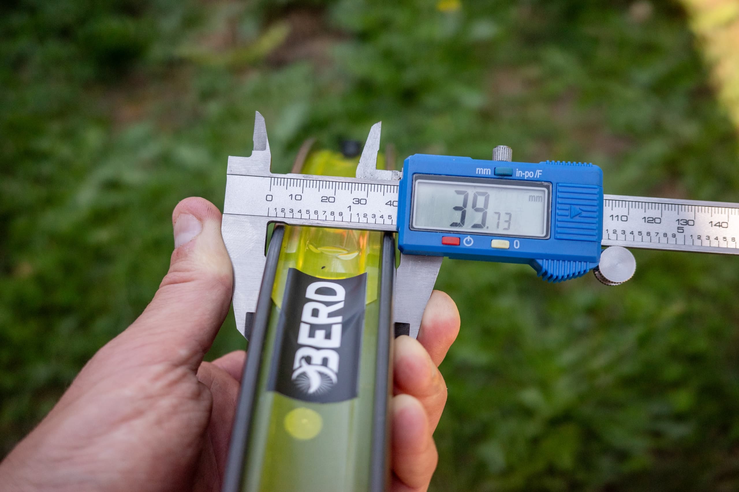 Measuring the Berd-branded water bottle included with the wheelset.