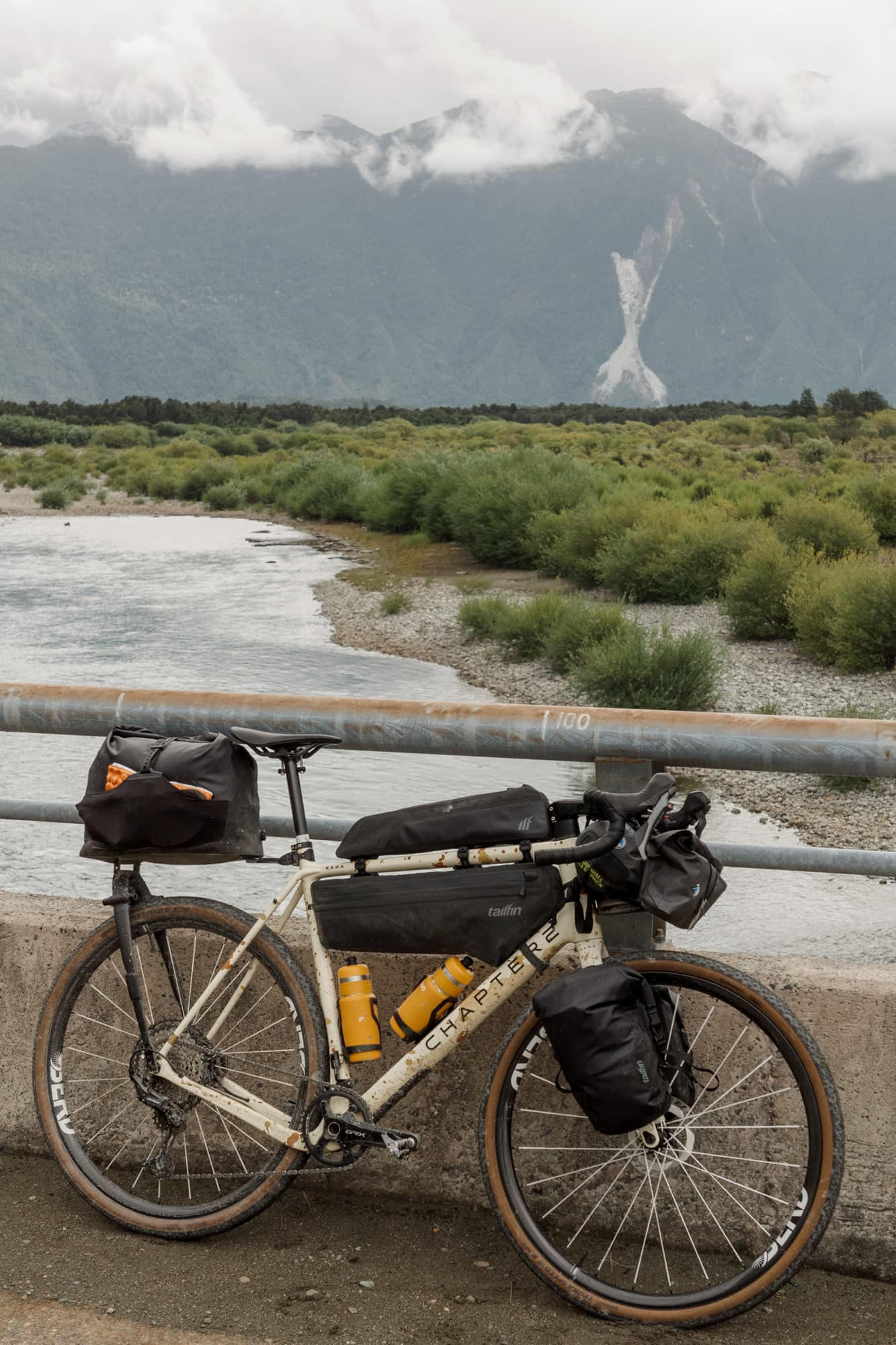 The loaded bike on a bridge above a glacial Patagonian river.