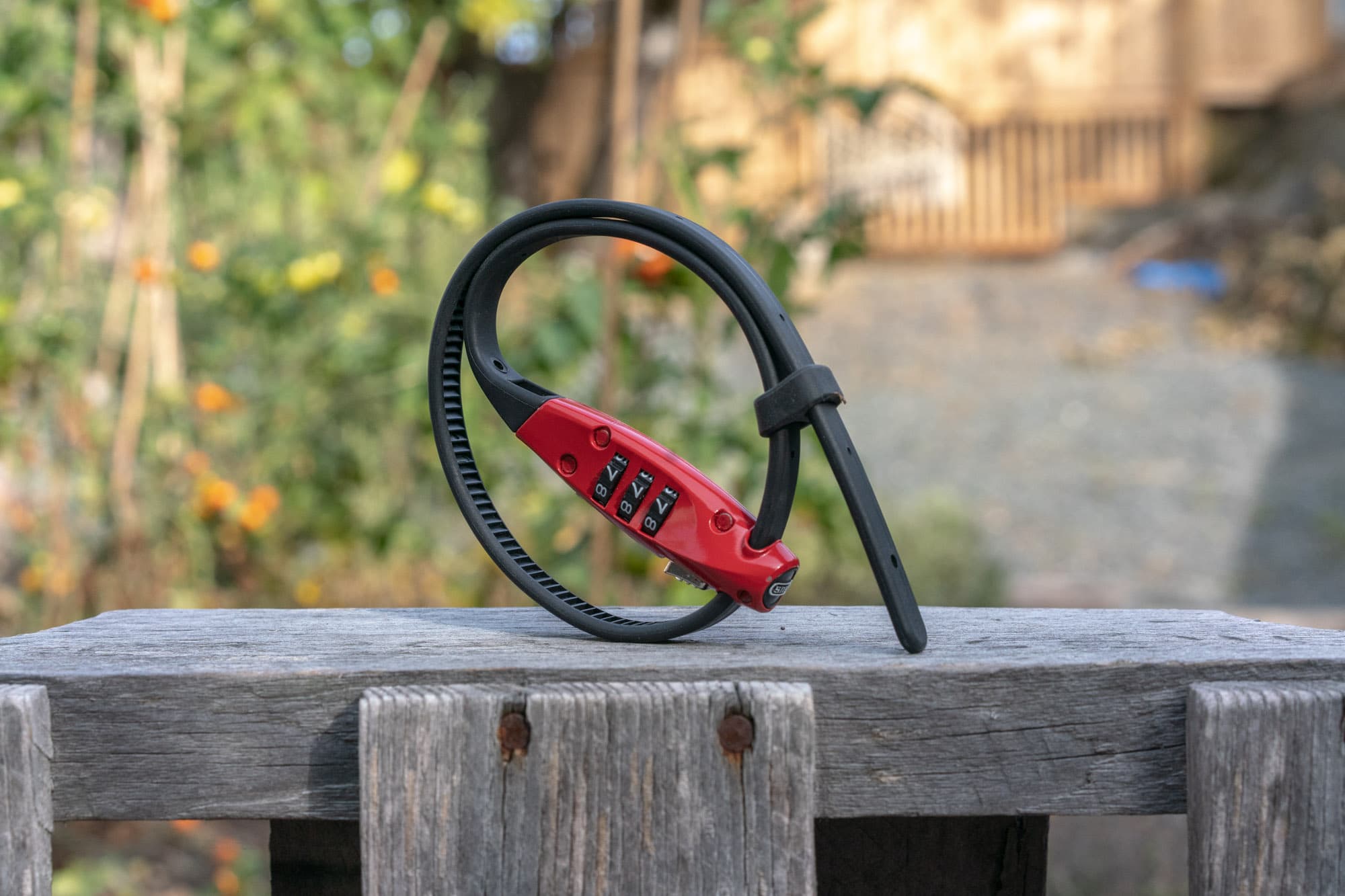 abus combiflex travelguard coiled on a wooden fence