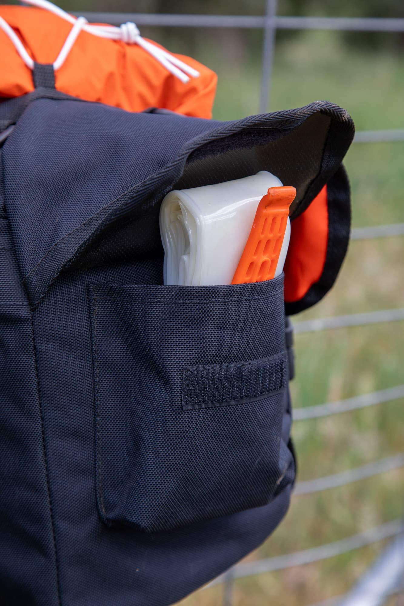 A side pocket of the Odyssey holding a sunscreen tube and tyre lever.