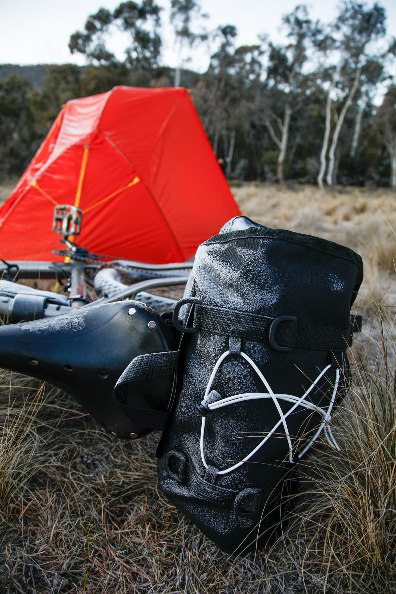 The Odyssey saddlebag propped by the bike on a frosty camp morning.