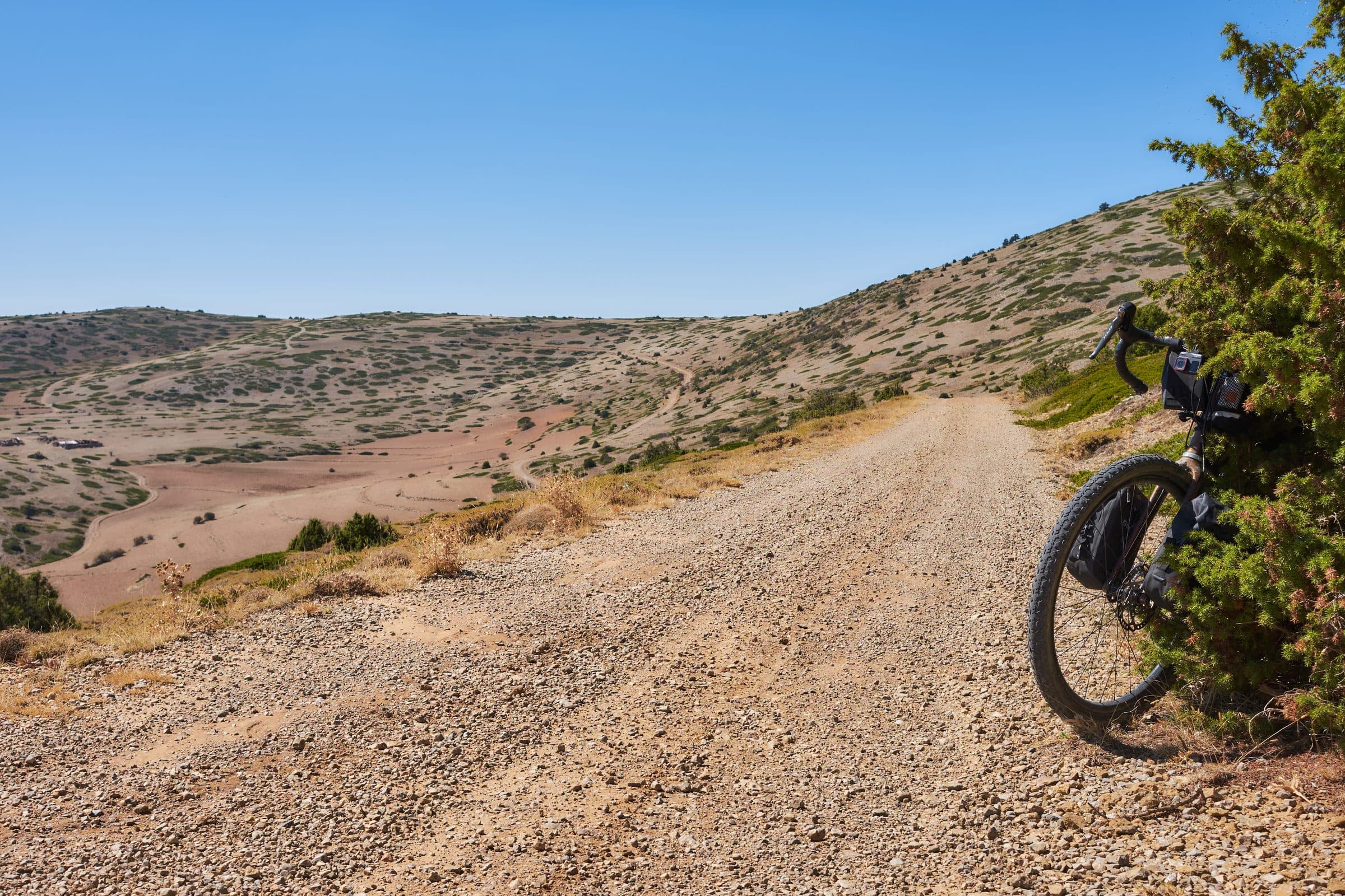 A loaded bike on an empty gravel road in the Teruel highlands.